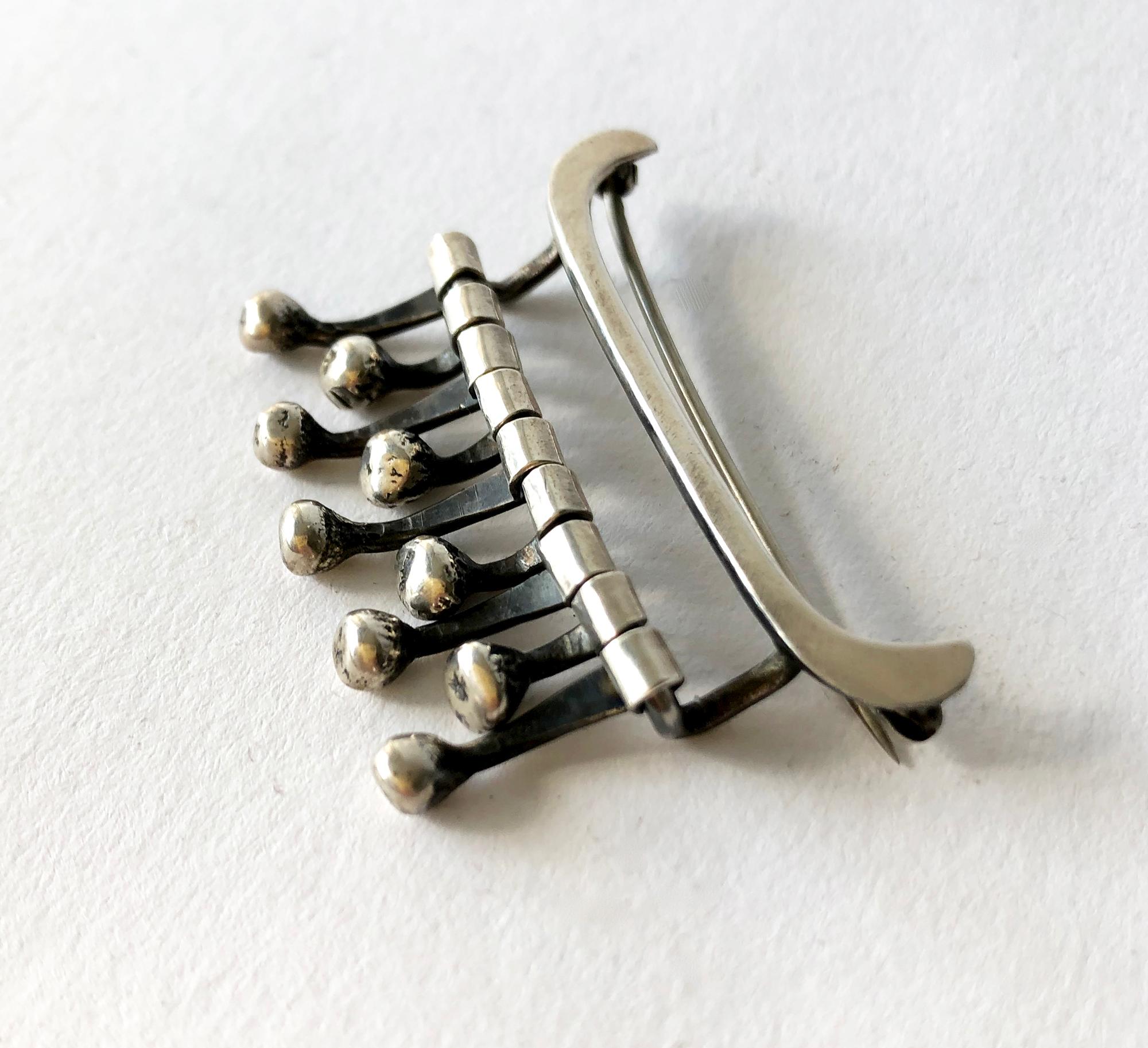 Kinetic, hand made sterling silver brooch created by Ruth Berridge of New York City, New York.  Brooch measures 1 1/2