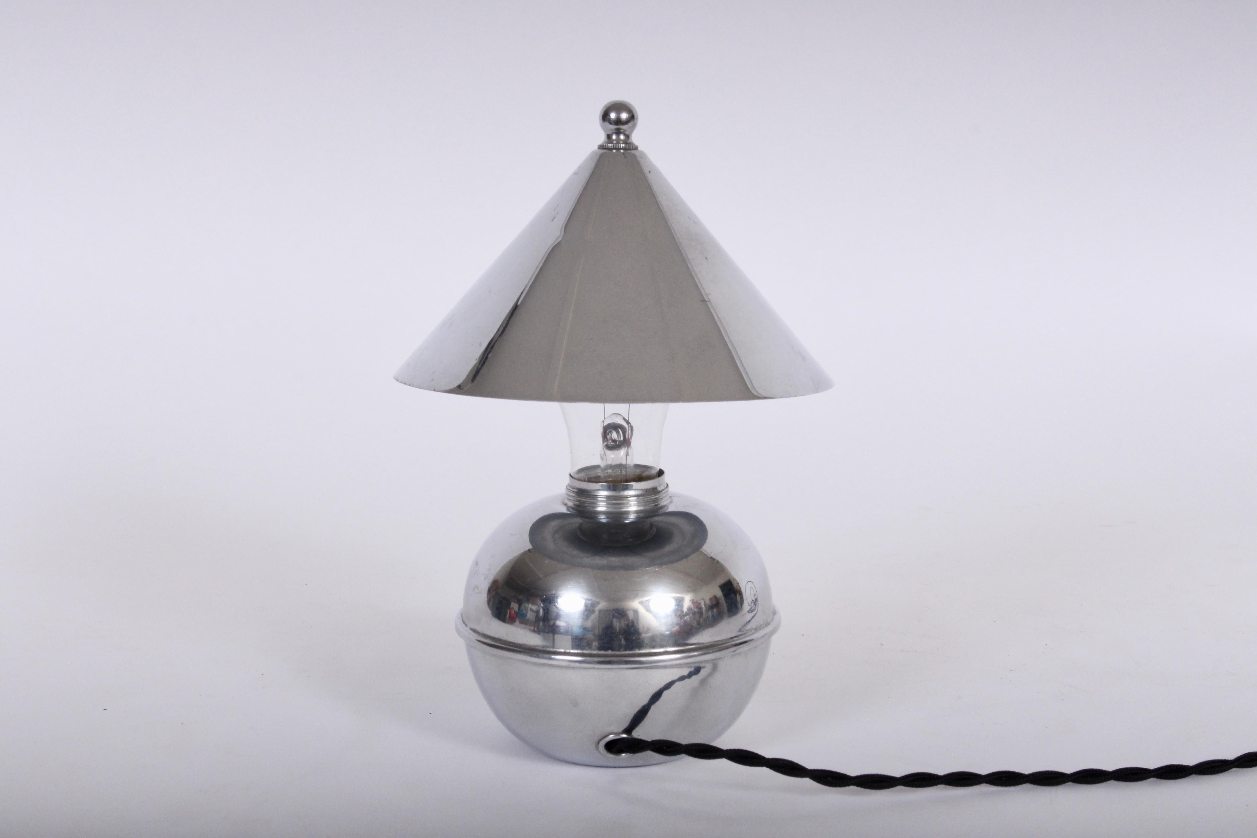 American Modernist Ruth Gerth reflective Chrome Accent Lamp for Chase Brass and Copper Company. Featuring all Chromed Plate pieces with conical clip Shade, globular finial, spherical 4D base and, horizontal banding. With Black Bakelite rotary