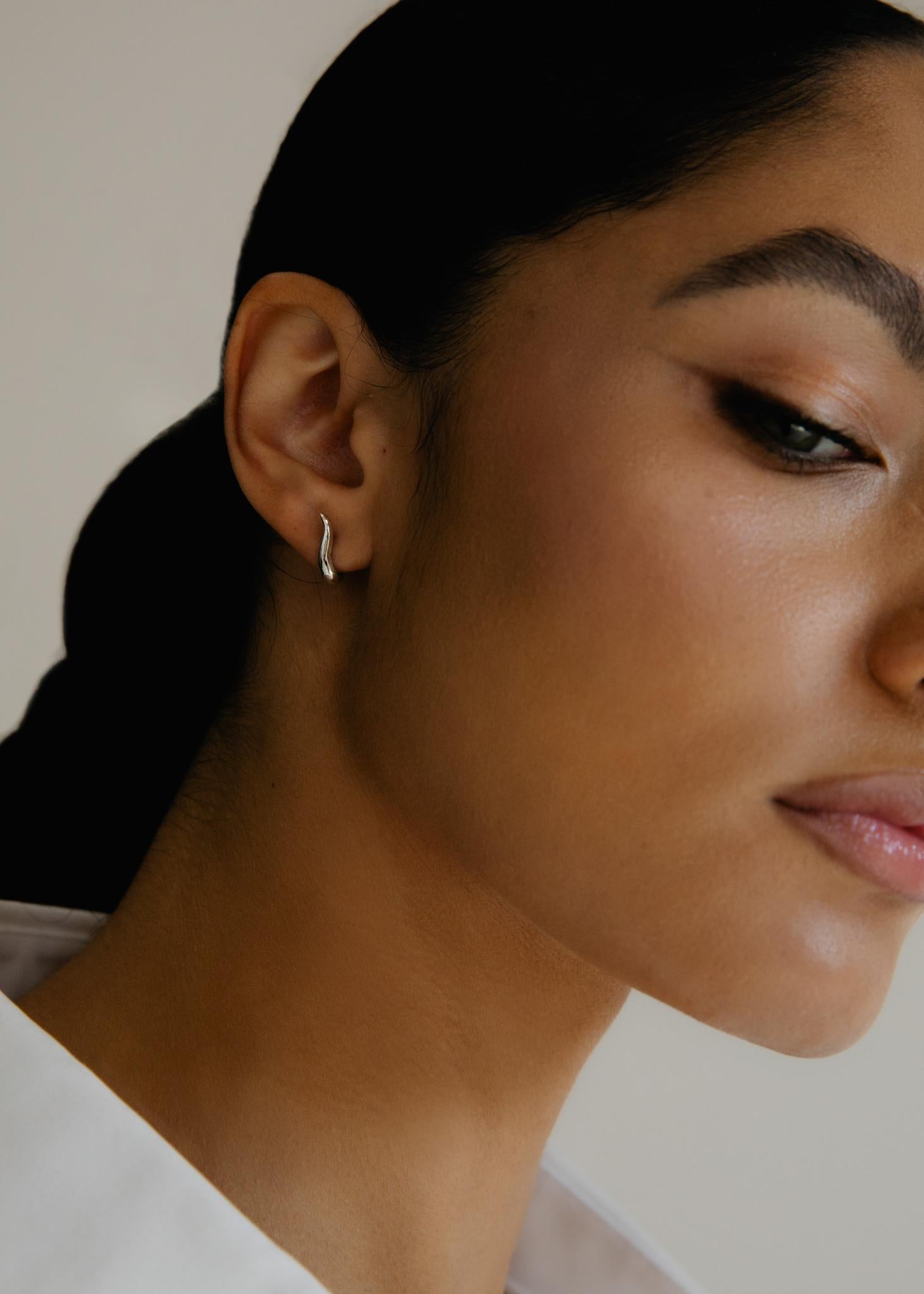 Organically shaped delicate hoops designed to sit closely to your ear.

-sterling silver
-post and pushback closure
-sold as a pair

Each Ruth Nyc piece is handmade to order in our NYC studios. Each piece is designed to become a personal talisman, a