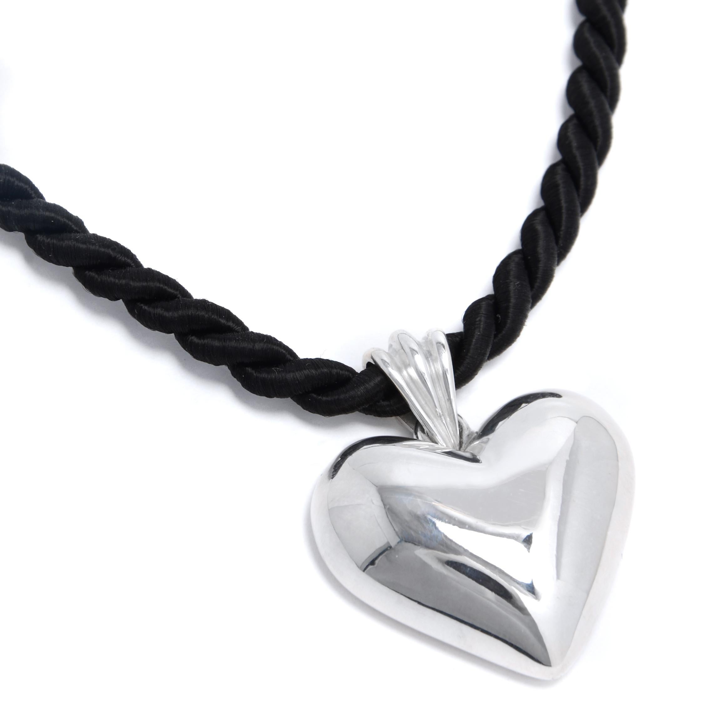 The Heavy Heart Pendant is crafted from heirloom-quality silver and hung on a twisted cotton cord. A piece that feels trend-forward, but is made to last forever. 

Lays flat on the neck
Adjustable between 16-18' inches
Lobster clasp closure 

Each