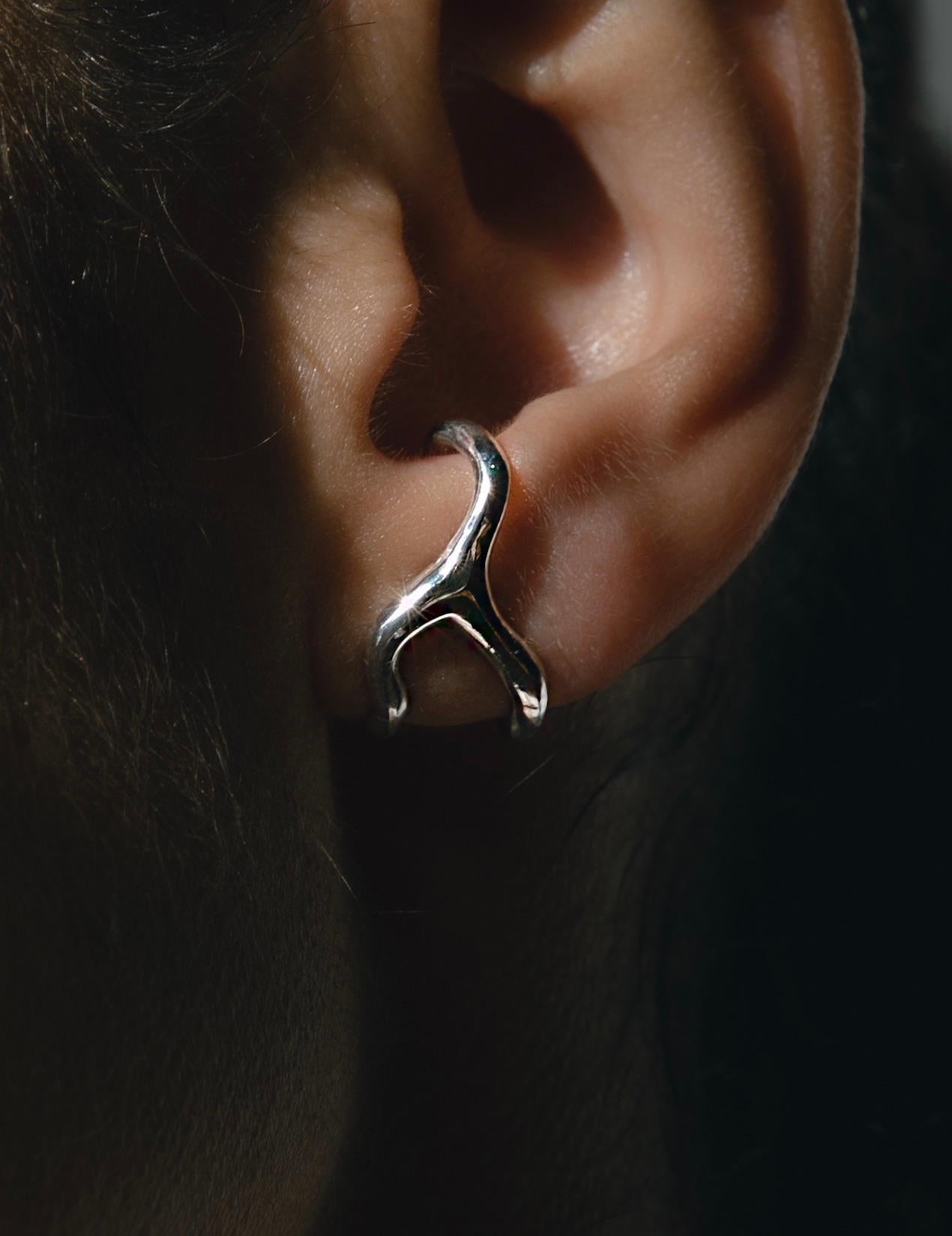 A hybrid between an ear cuff and an earring, the Zephyr is designed to gently wrap around the ear with the added security of a post and push back closure. 

-Sterling Silver 
-post and pushback closure, this piece requires a pierced ear. 
-sold as a