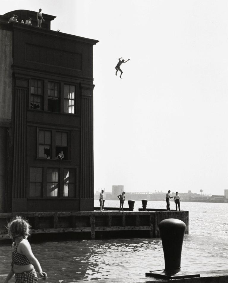 Ruth Orkin Portrait Photograph - Boy Jumping into Hudson River, Gansevoort Pier