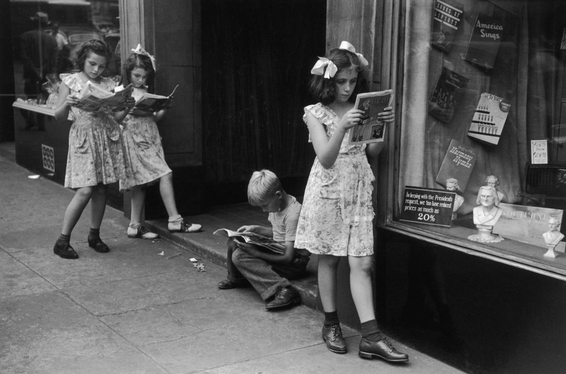 Ruth Orkin Black and White Photograph - Comic Book Readers, West Village, NYC