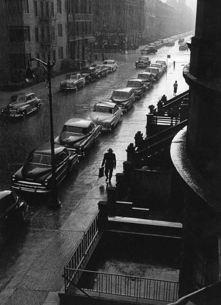 Ruth Orkin Black and White Photograph - Man in Rain West 88th Street, NYC - New York, City Scene, Silhouette, Cars, Road