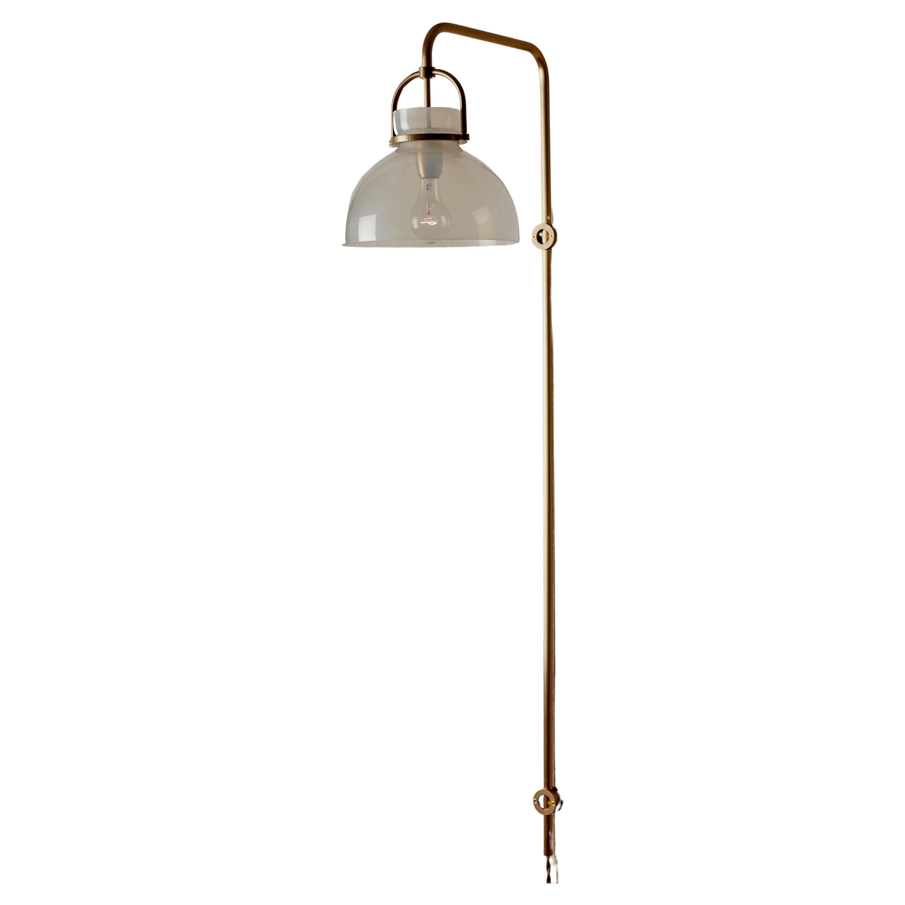 The studious Ruth Wall Sconce features a hand-blown glass shade and bent brass arm captured by bespoke brass hardware. Choose either a clear glass shade for bright and direct light or an iridescent opal glass shade for a subdued ambiance.

OVERALL