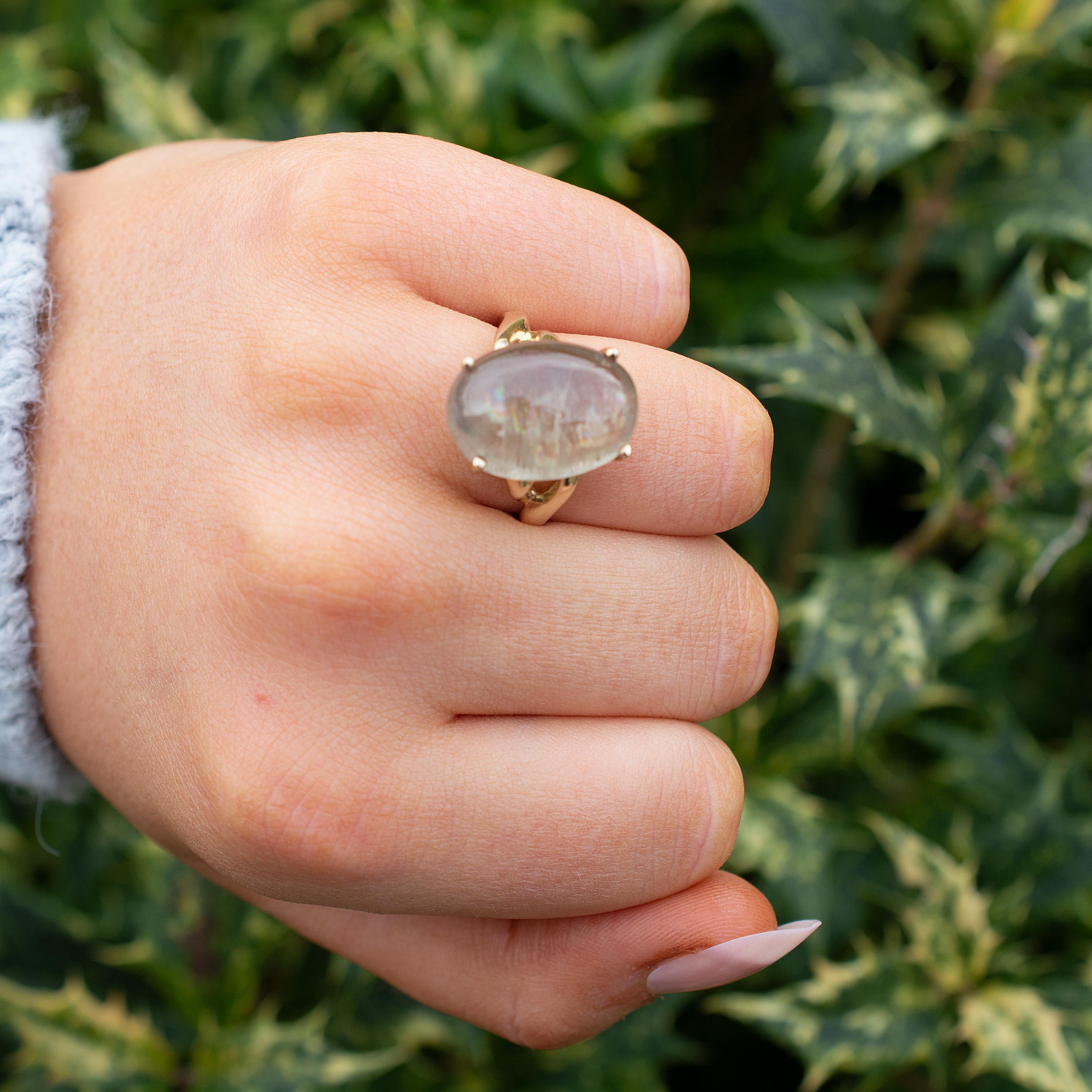 A seductive Rutilated Quartz cocktail ring crafted in 9 karat yellow gold.

The polished stone has a mesmerizing translucent olive green color with golden color inclusions known as ' Rutile'. Rutilated Quartz gemstones are unique in its pattern of