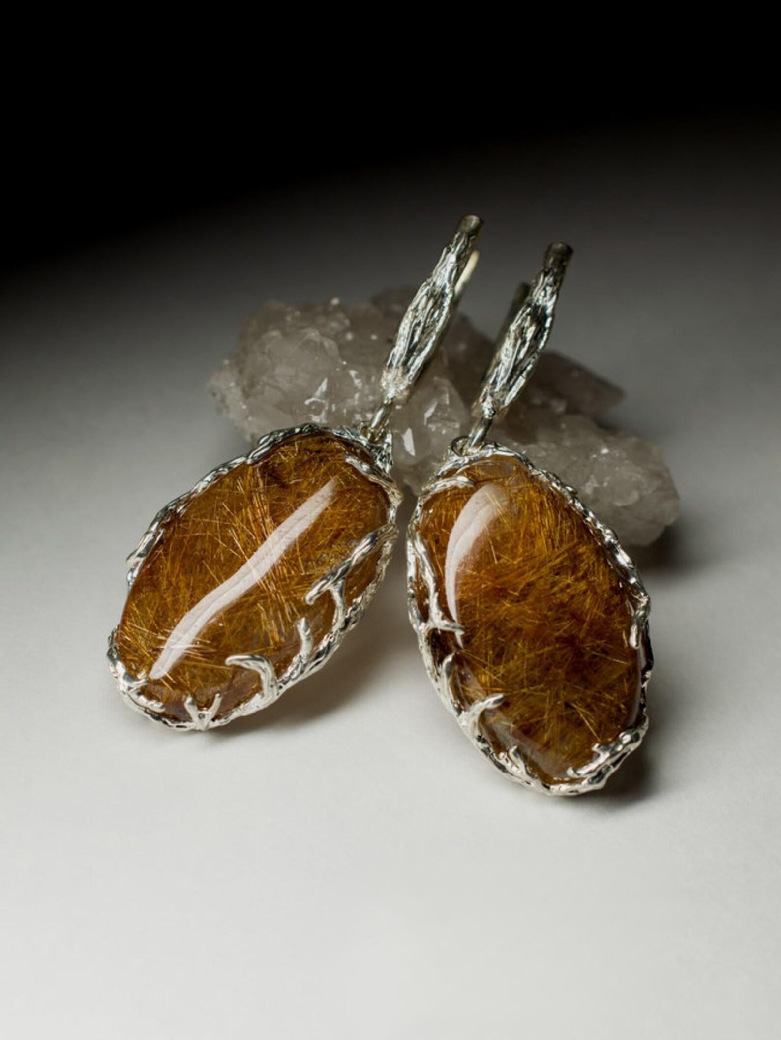 Long silver earrings with natural Rutilated Quartz
gemstone origin - Brazil
earrings weight - 17.3 grams
earrings length - 1.97 in / 50 mm
gem size is 0.28 x 0.63 x 1.18 in / 7 х 16 х 30 mm
stones weight - 43.62 carats