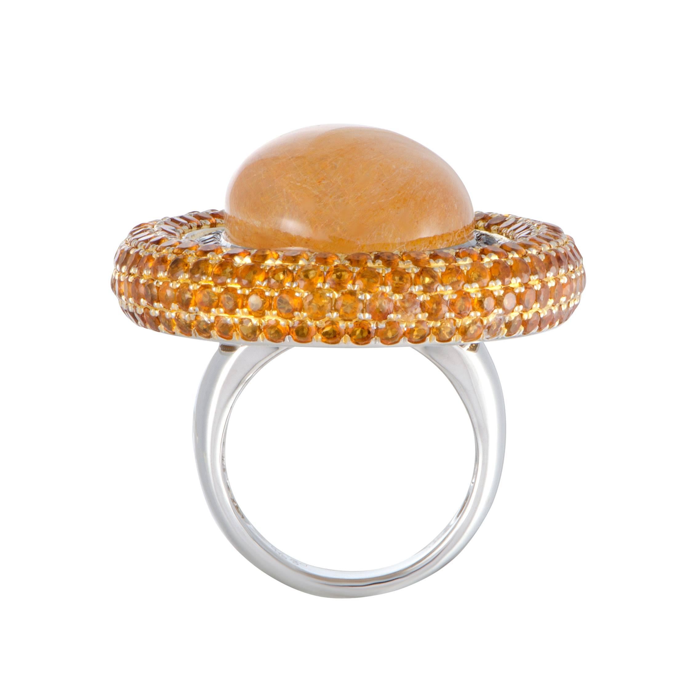 Slightly reminiscent of a stylish ladies’ hat, this fashionable ring endears with its extraordinary design and spellbinding décor. Made of 18K white gold, the ring is set with rutilated yellow quartz, 6.60 carats of citrines, and 0.75 carats of