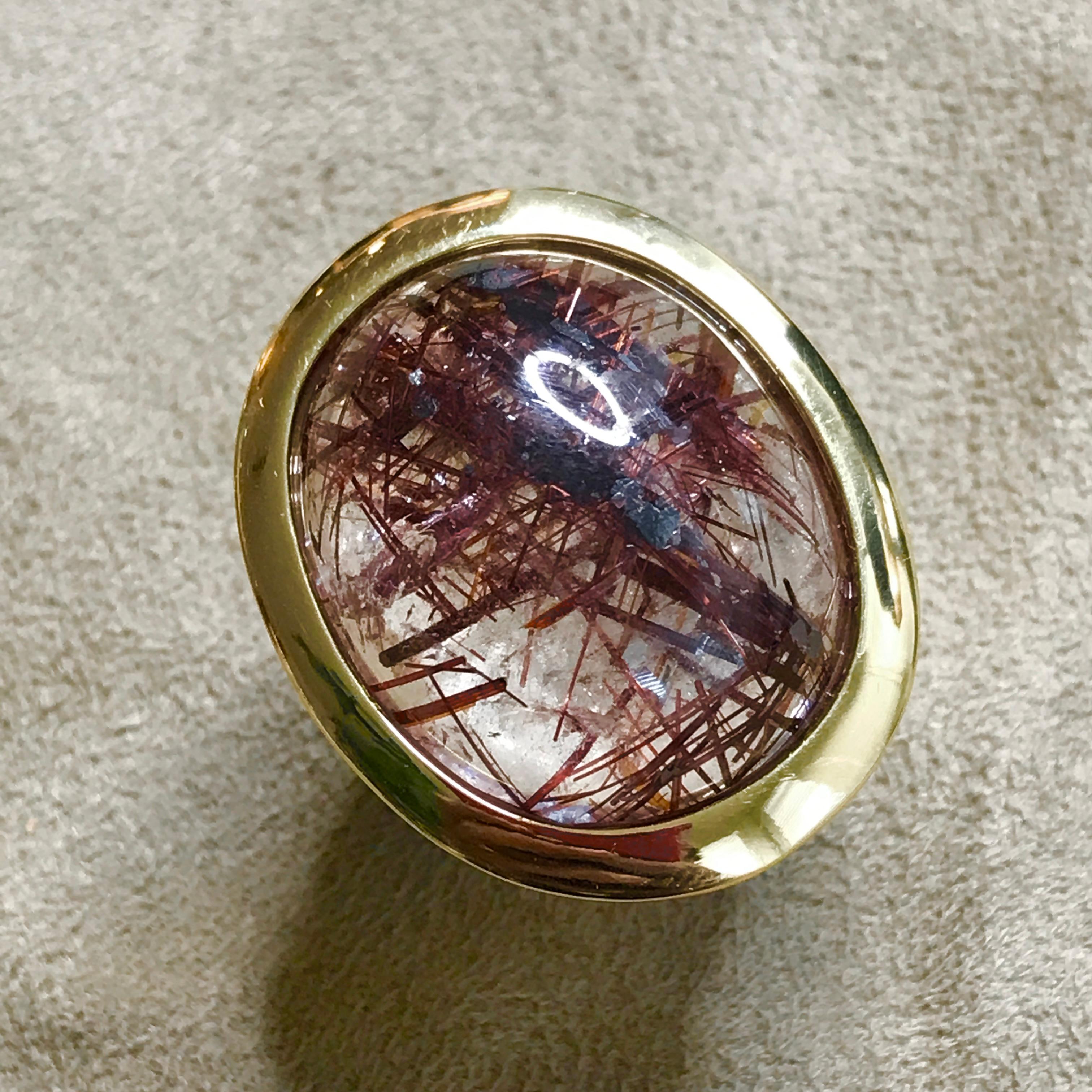 A wonderfully bold & striking ring made in Sterling Silver with a Gold plated 'top line' centring on a fabulous, large Rutile Quartz gemstone.

Rutile Quartz is a glorious stone - the naturally occurring inclusions which form the interwoven lines