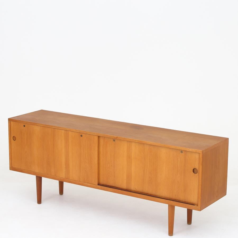 RY 26 - Sideboard in oak with two sliding doors and interior. Maker Ry Møbler.