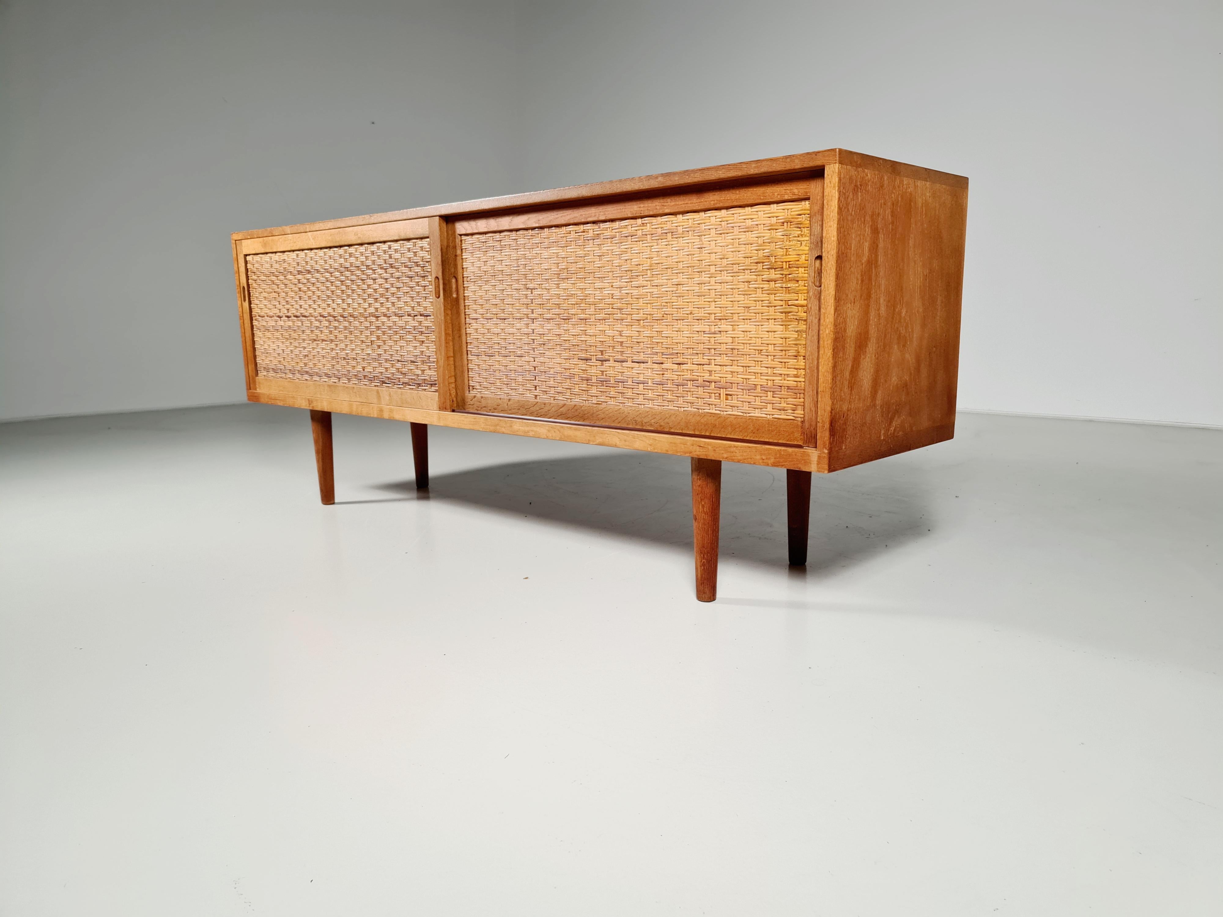 Amazing RY26 sideboard in oak with teak veneer designed by Hans Wegner for RY Mobler, Denmark. 1950. Rare example of this beautiful sideboard with cane doors. Simple, elegant details and wonderful interior.