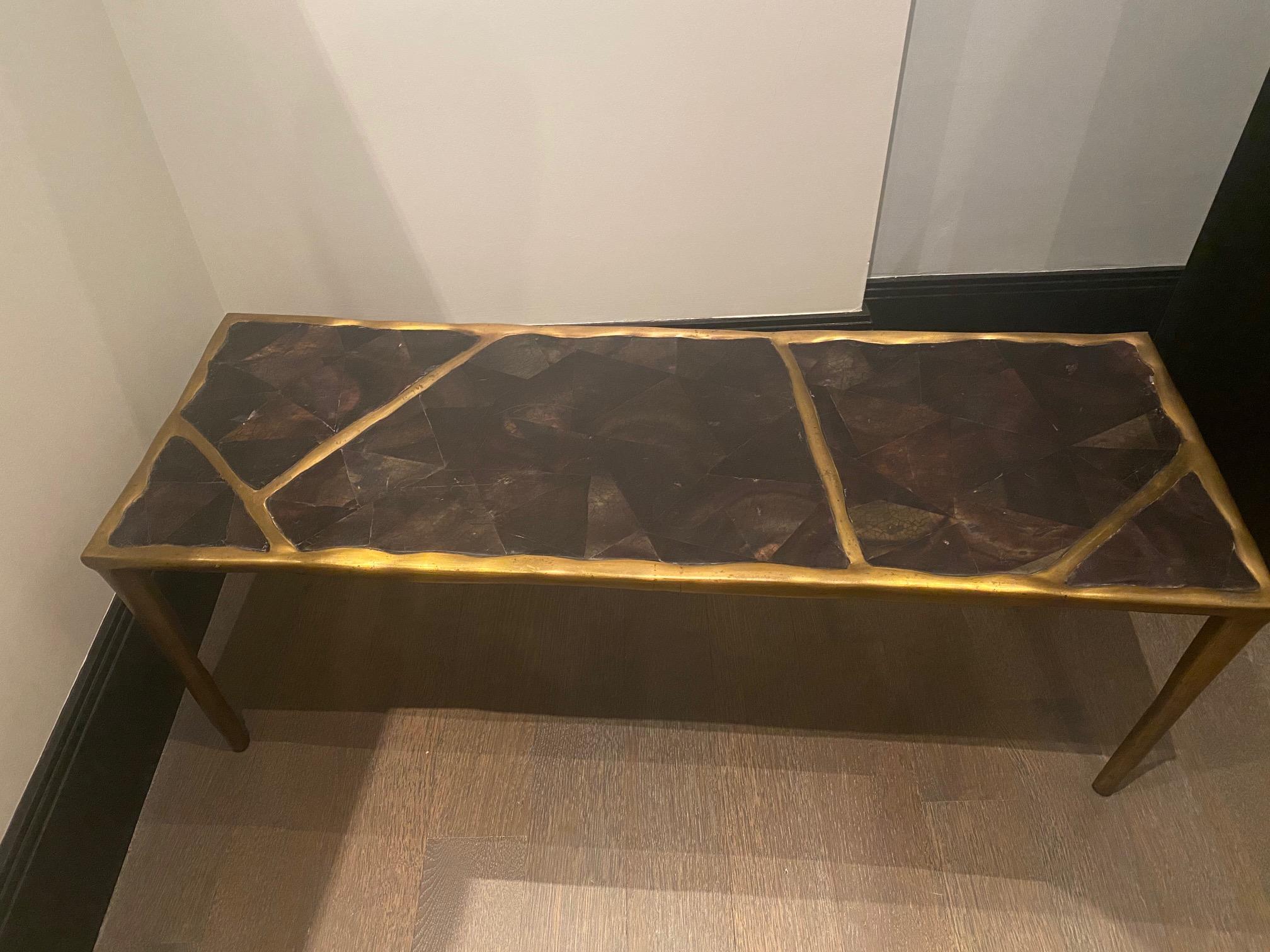 R&Y Augousti bronze and black shell coffee table.