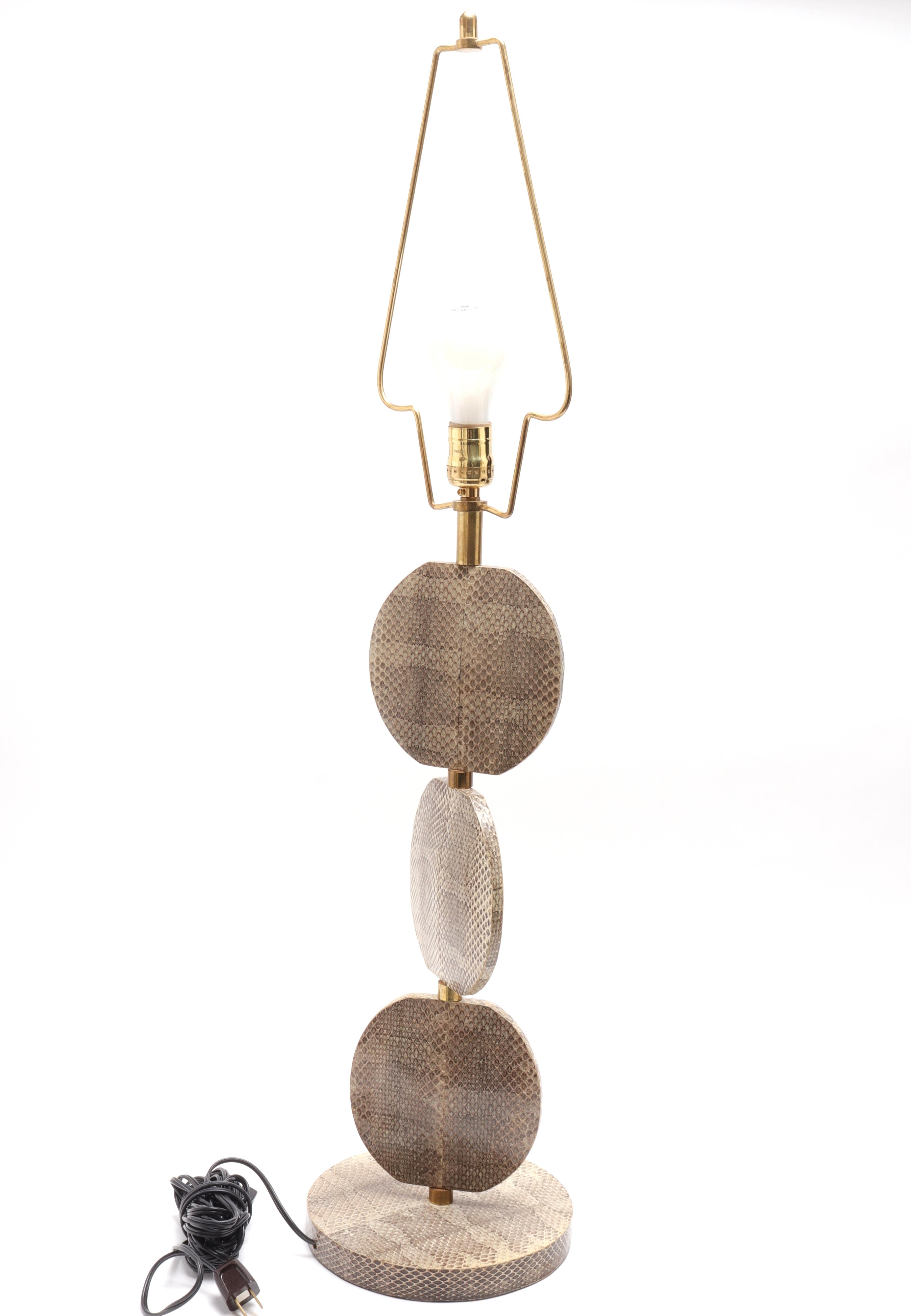 R & Y Augousti French modern snakeskin table lamp in triple disc form with round base, maker's mark underside.
Lamp base: 21
