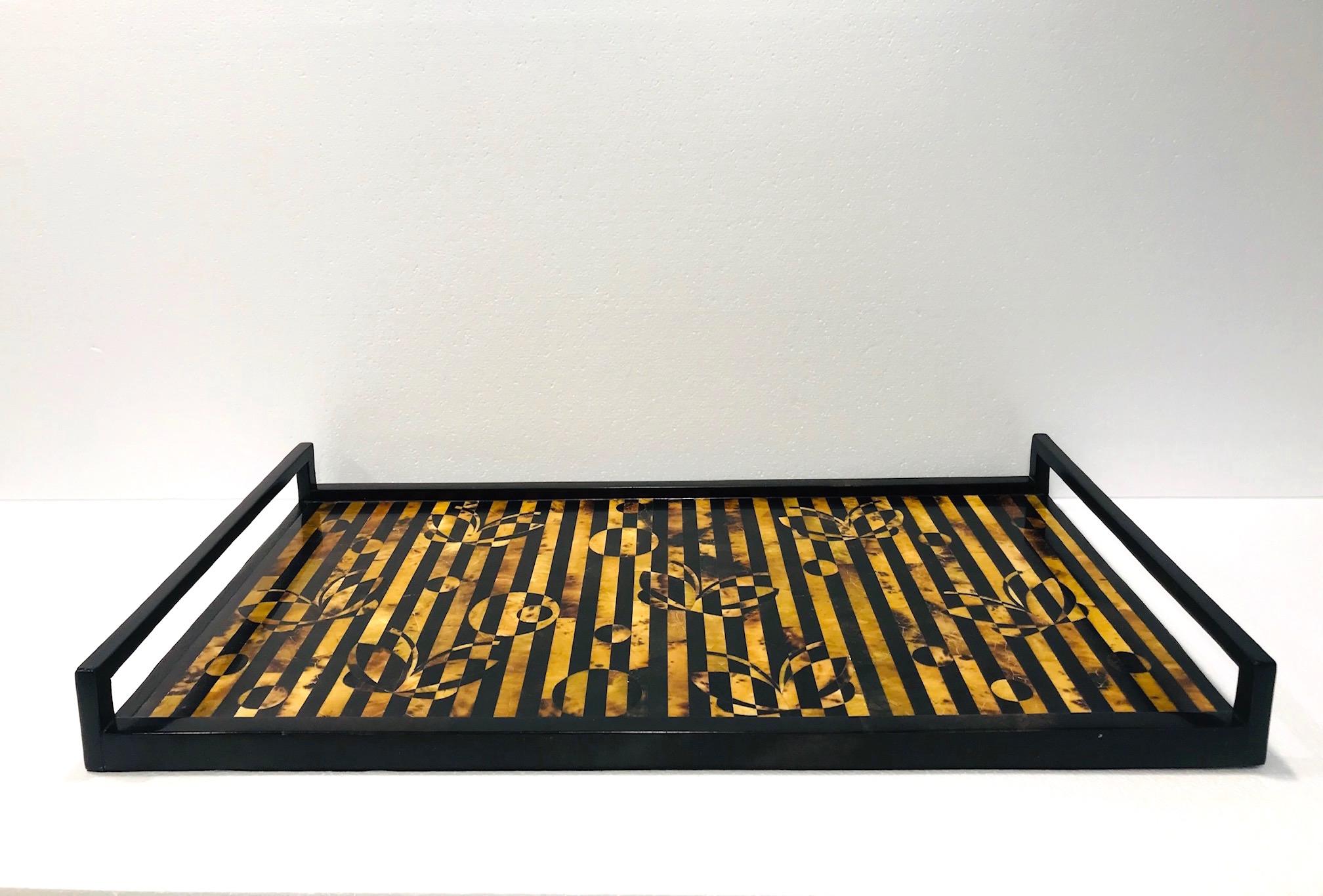 Organic modern decorative serving tray by R & Y Augousti. All handcrafted in fine exotic materials featuring lacquered and hand-dyed pen shell over a wood frame. Rectangular tray comprised of shell inlays in a series of stripes in tones of black,