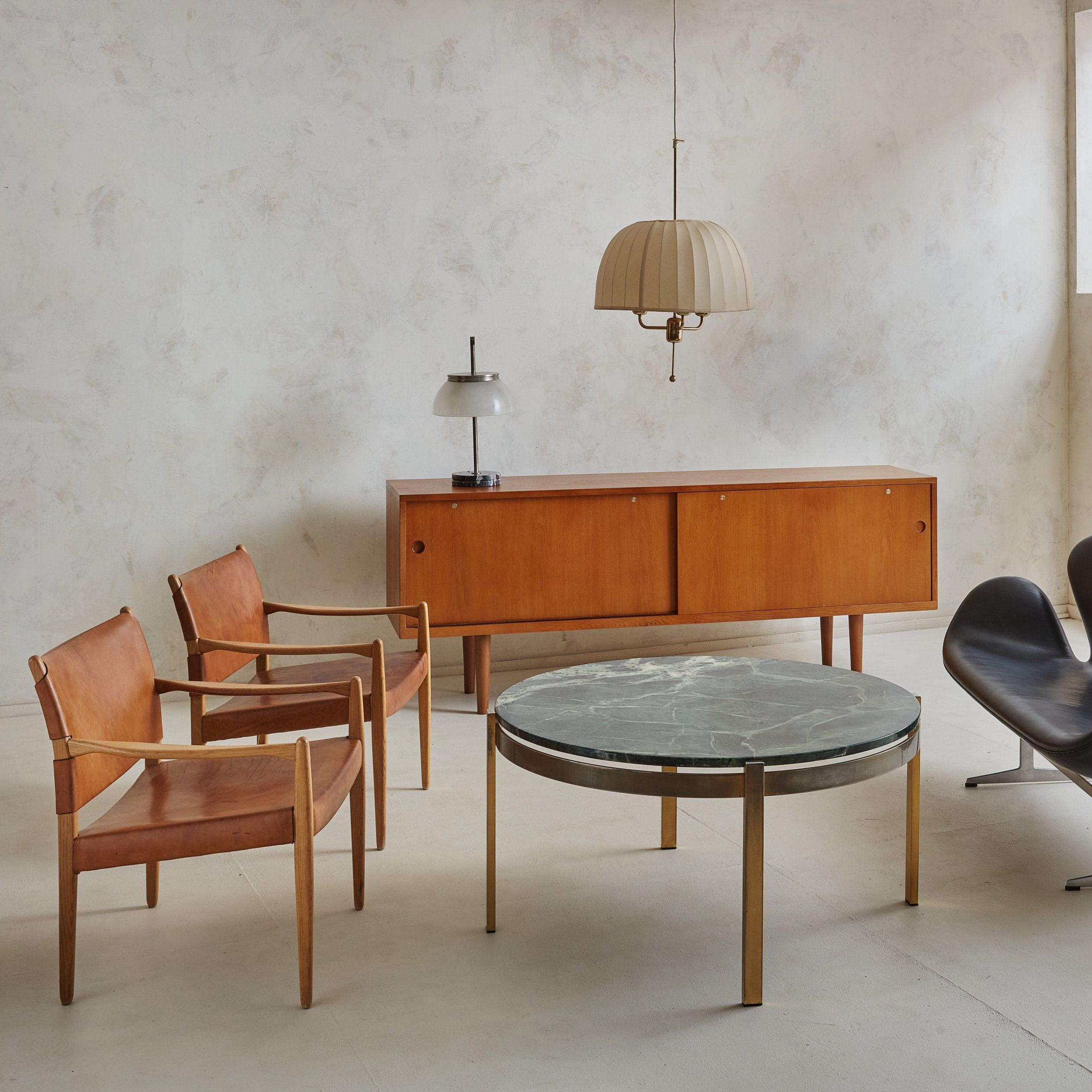 A rare model ‘RY-26’ ash wood sideboard designed by Danish architect Hans Wegner and produced by Ry Møbler in the 1950s. This Mid-Century Modern sideboard is composed of delicately grained ash wood with a warm, honey hued stain. Two sliding drawers