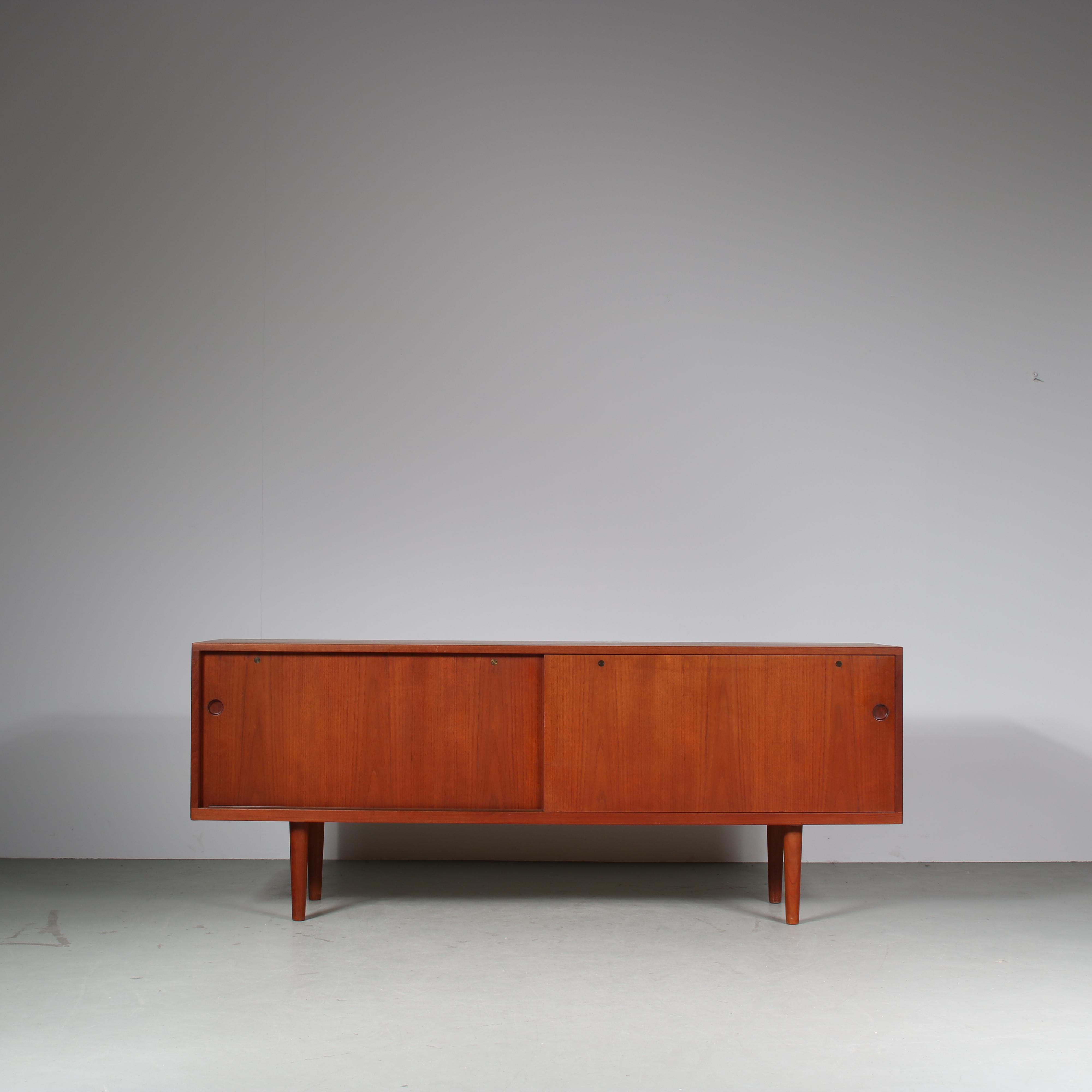 A lovely sideboard, model 26, designed by Hans J. Wegner, manufactured by RY Mobler in Denmark around 1960.

This appealing piece has a minimalist yet modern style. Made of high quality, warm brown teak wood in a rectangular shape with gently