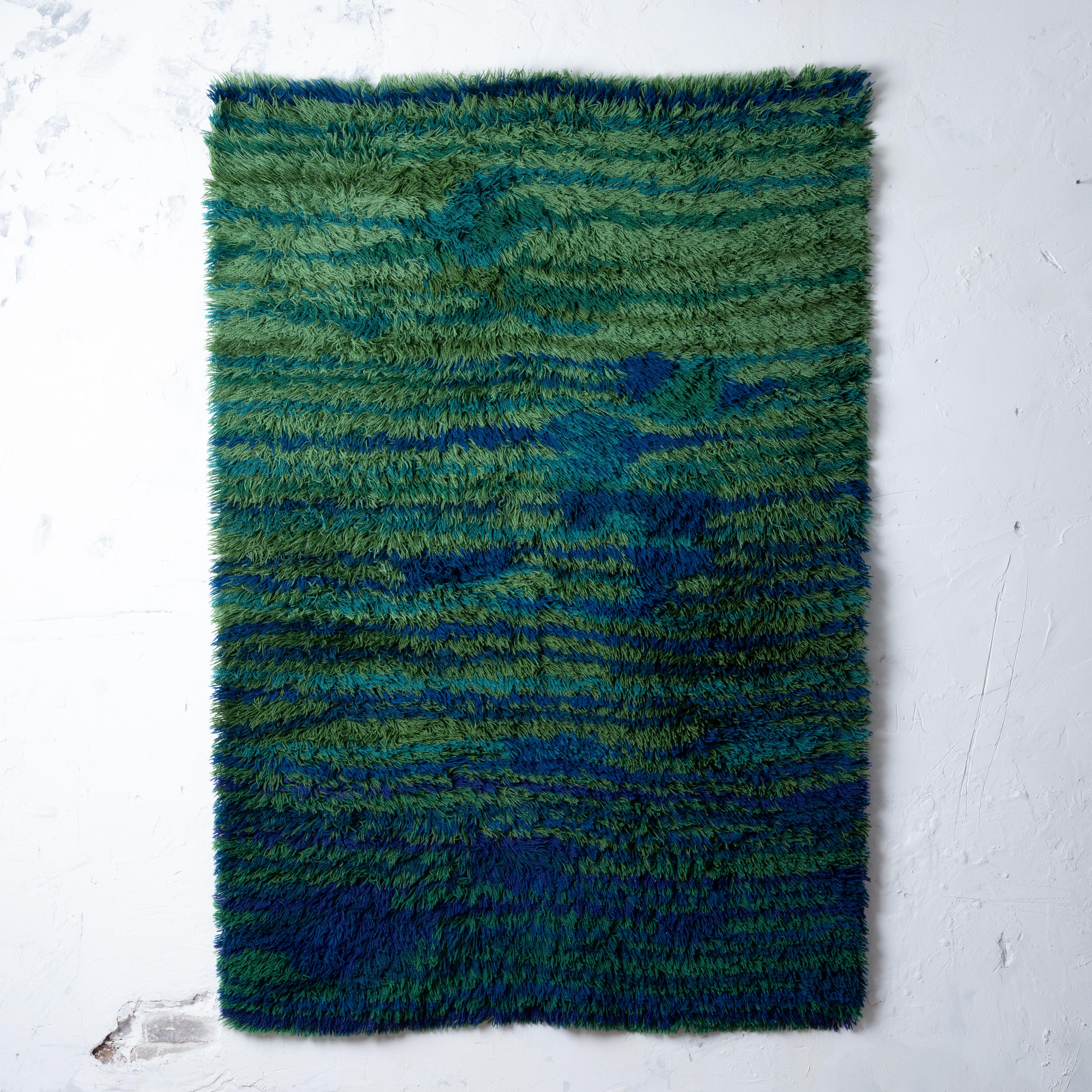 A green and blue Danish modern rya shag rug, 1960s.

55 by 80 inches