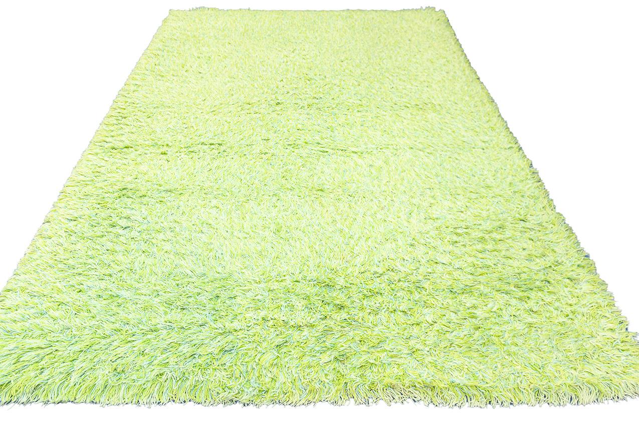 This is a truly unique Rya Swedish rug in a serene green color, featuring a minimalist design that embodies simplicity and elegance. This exceptional piece stands out for its understated beauty and meticulous craftsmanship, making it a special find