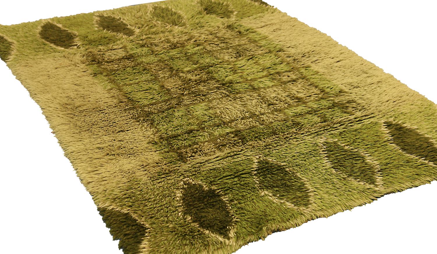This is a beautiful, hand-knotted rya rug with an abstract design in olive green. This piece is woven around 1920-1950 with turkish knots, which create a thick and durable pile. Rya rugs are perfect for high-traffic areas because they are so durable