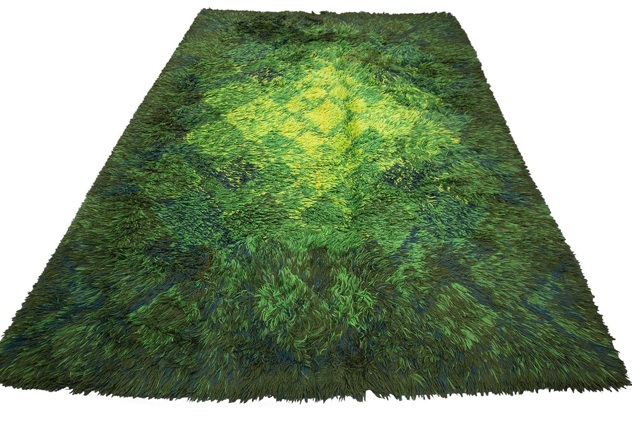 Introducing our luxurious Scandinavian Rya Rug that has taken the interior design world by storm! Crafted with the finest woolen piles, this stunning rug features a shaggy texture in shades of green that brings a refreshing touch to any living