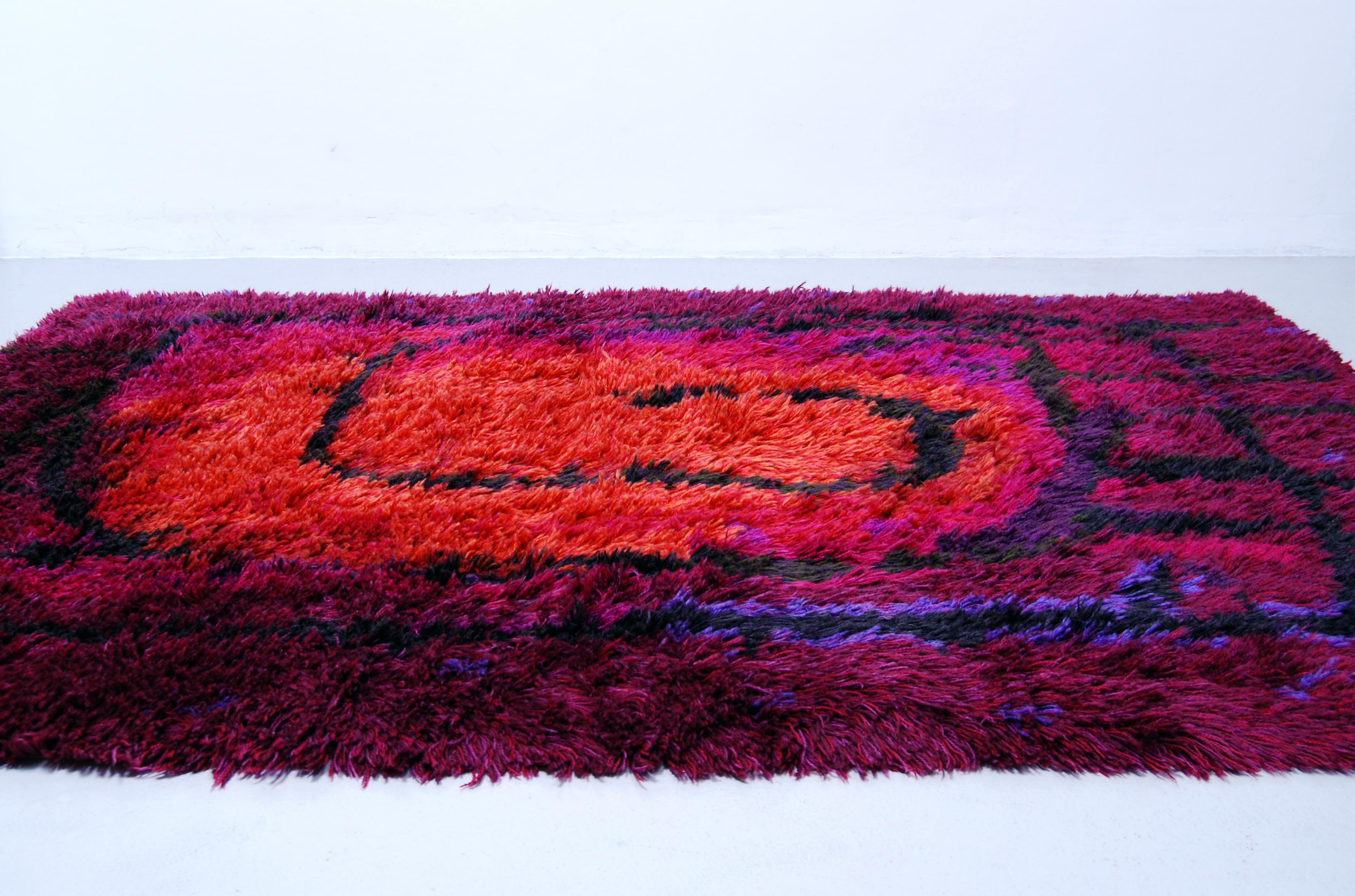 Danish Rya rug / carpet by Ege Rya with a great abstract, fire pattern design in various shades of purple, orange, pink, black and blue. Suitable as a carpet or as a wall-hung work of art. Professionally water cleaned.


 