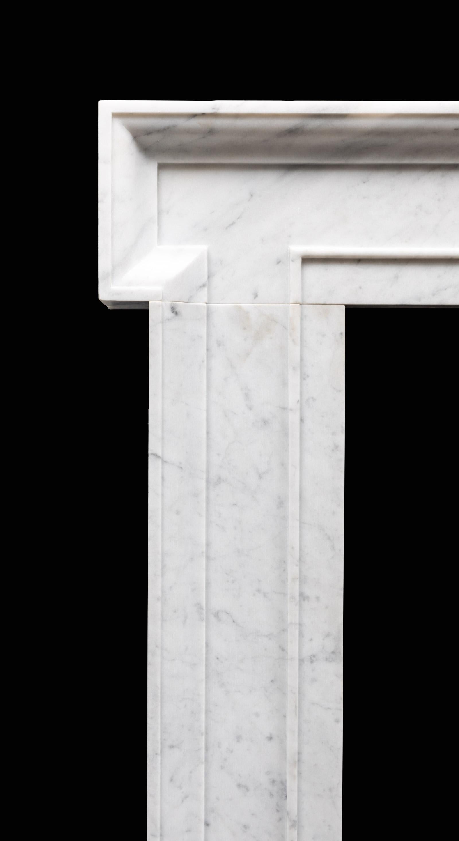 An architectural Carrara marble fireplace surround in the manner of John Vanbrugh. Made from solid blocks of Italian Carrara marble, with moulded dog leg jambs and simple frieze resting on plain square plinths. 

Early 18th century in a style which