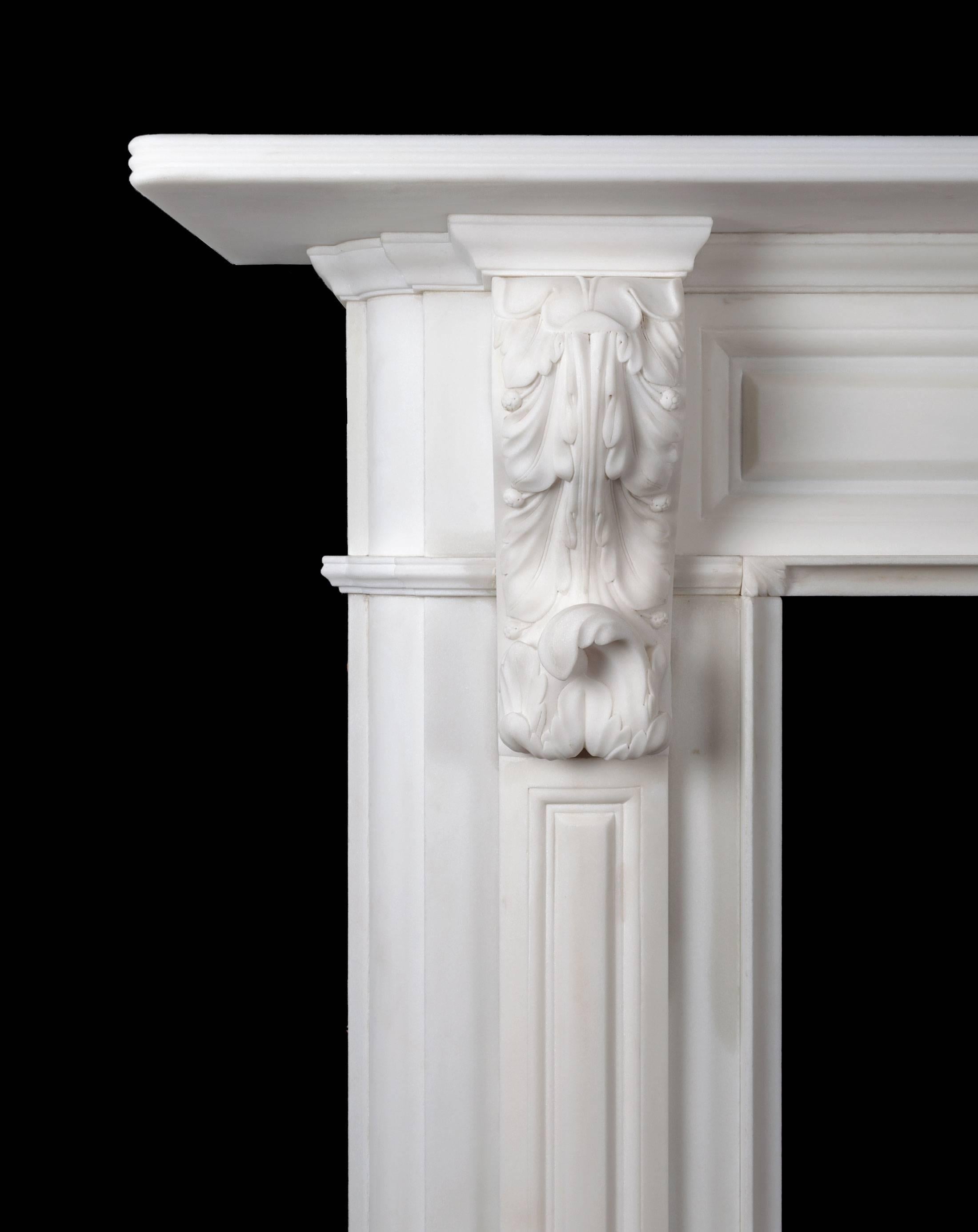 Carved Irish corbel marble fireplace by Ryan & Smith. A beautifully carved and well-proportioned large white marble fireplace, with carved acanthus bracket corbels and basket of flowers centre plaque. This style of fireplace is found in the finest