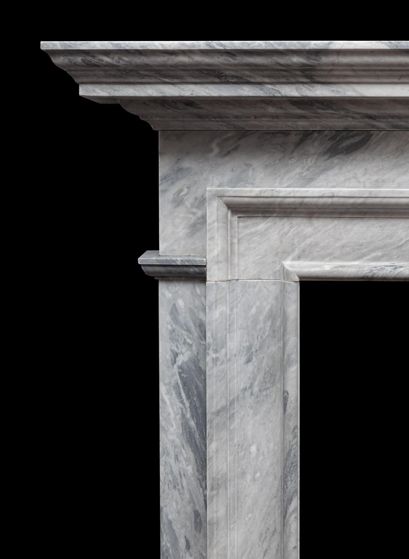 A dove grey Bardiglio marble fireplace with clean architectural lines. Produced in a softly coloured grey Italian marble with a hand waxed satin finish. Suitable for both modern and traditional interiors.