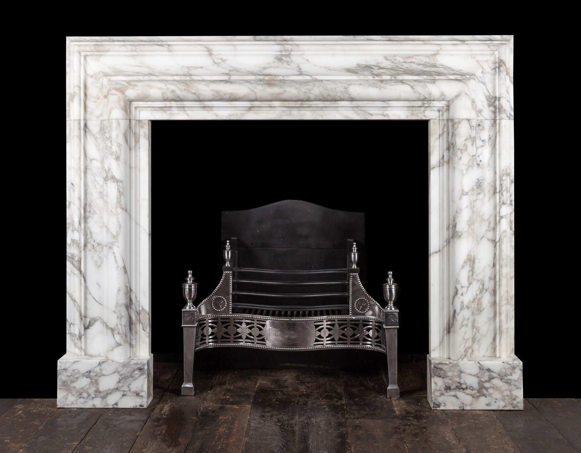 A large bolection fireplace surround of generous proportions 
The substantial 12? (300mm) wide bolection moulded frame, rests on plain square plinths.
Carved from a block of beautifully figured, Arabscato Carrara marble, hand selected in Italy by