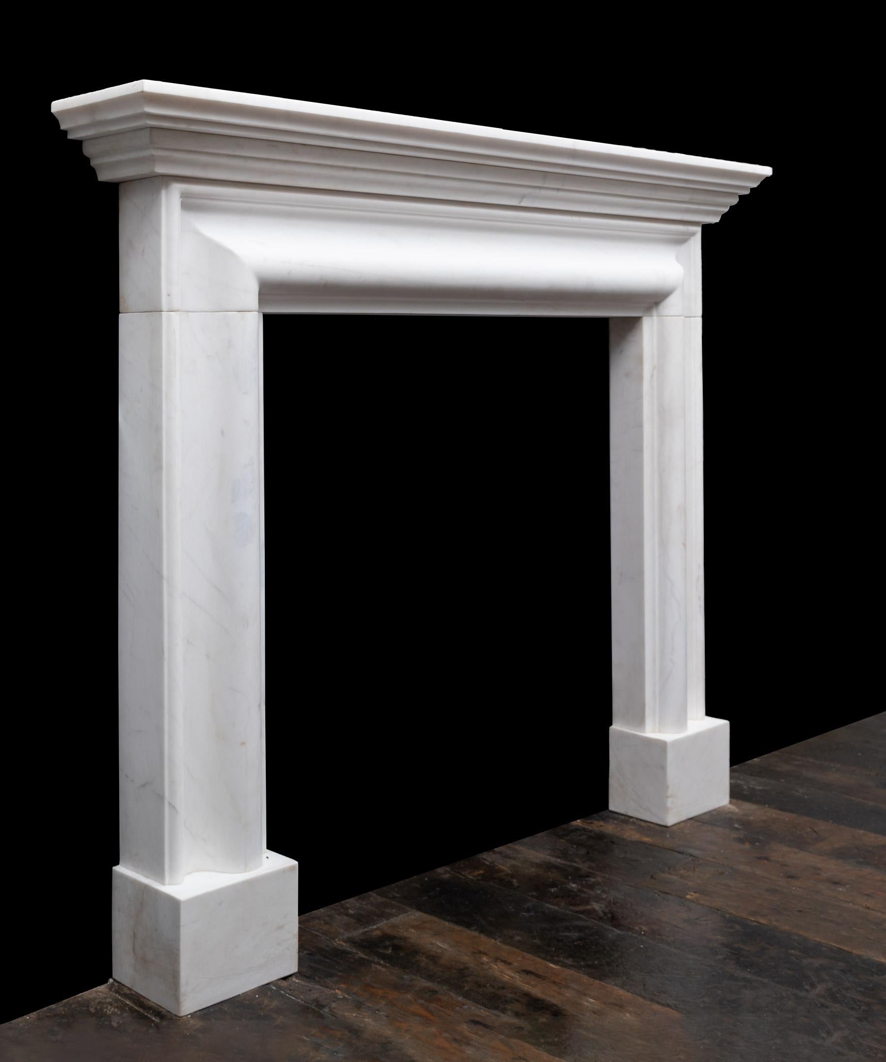 A stylish and fashionable fireplace design produced in white statuary marble. The fireplace has a moulded bolection frame on plain plinths, with a stepped cornice shelf on top.

A classic design fashionable in Europe for over three hundred years.