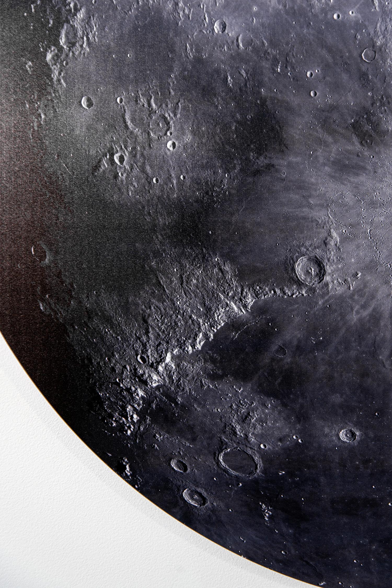 As a child, Ryan Van Der Hout owned a telescope and was fascinated by the sight of the moon in the night sky. This iconic image of the moon as viewed from earth is re-imagined when Van Der Hout folds the full colour photographic print he created.