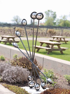 Used Action - tall, dynamic, reflective, geometric, abstract, steel outdoor sculpture