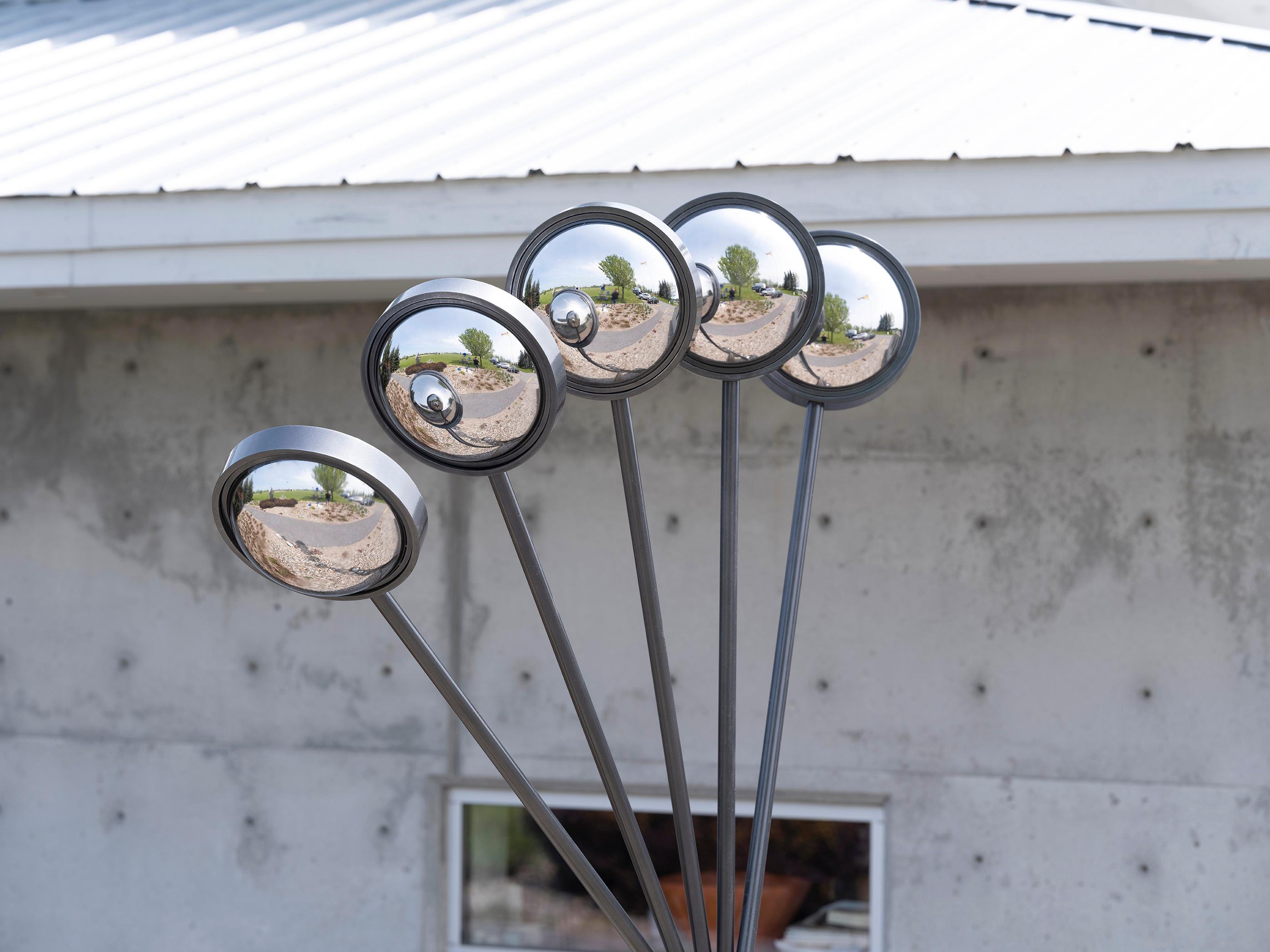 A multitude of polished mirrors shine as light bounces off them, reflecting the landscape and you. This is Ryan Van Der Hout’s elegant contemporary sculpture called Mirror Mirror. Inspired by their work as a professional photographer, this