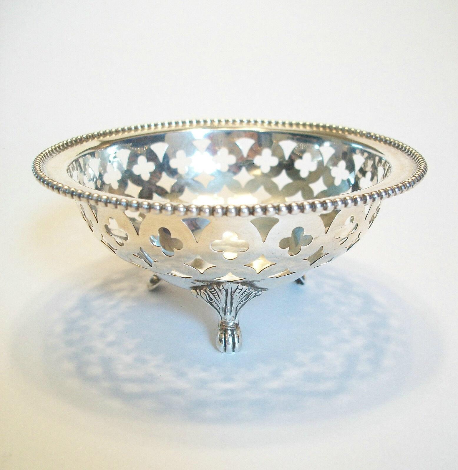 
RYRIE BROTHERS - Antique sterling silver bonbon or nut dish - featuring a pierced quatrefoil basket design on three scrolled feet with a beaded border rim - signed on the base - Canada - early 20th century.

Excellent antique condition - all