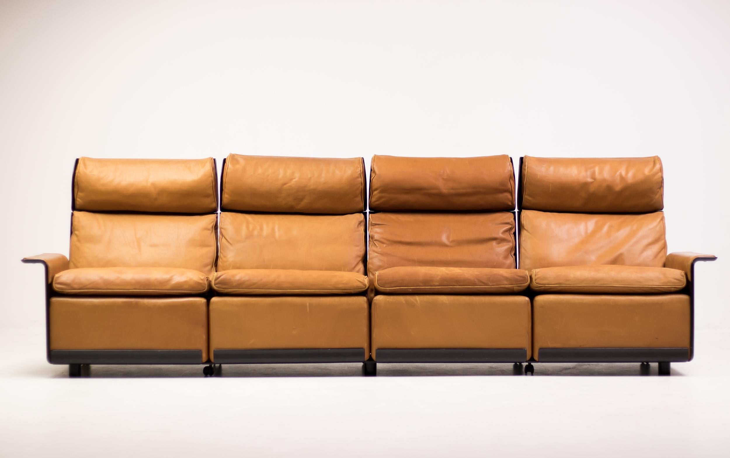 RZ620 four-seat sofa in cognac leather and black fiberglass by Dieter Rams for Vitsoe. 
Rare Dieter Rams piece in all original condition. 
Small tear in one of the armrests, but that piece of leather can easily be replaced when required.