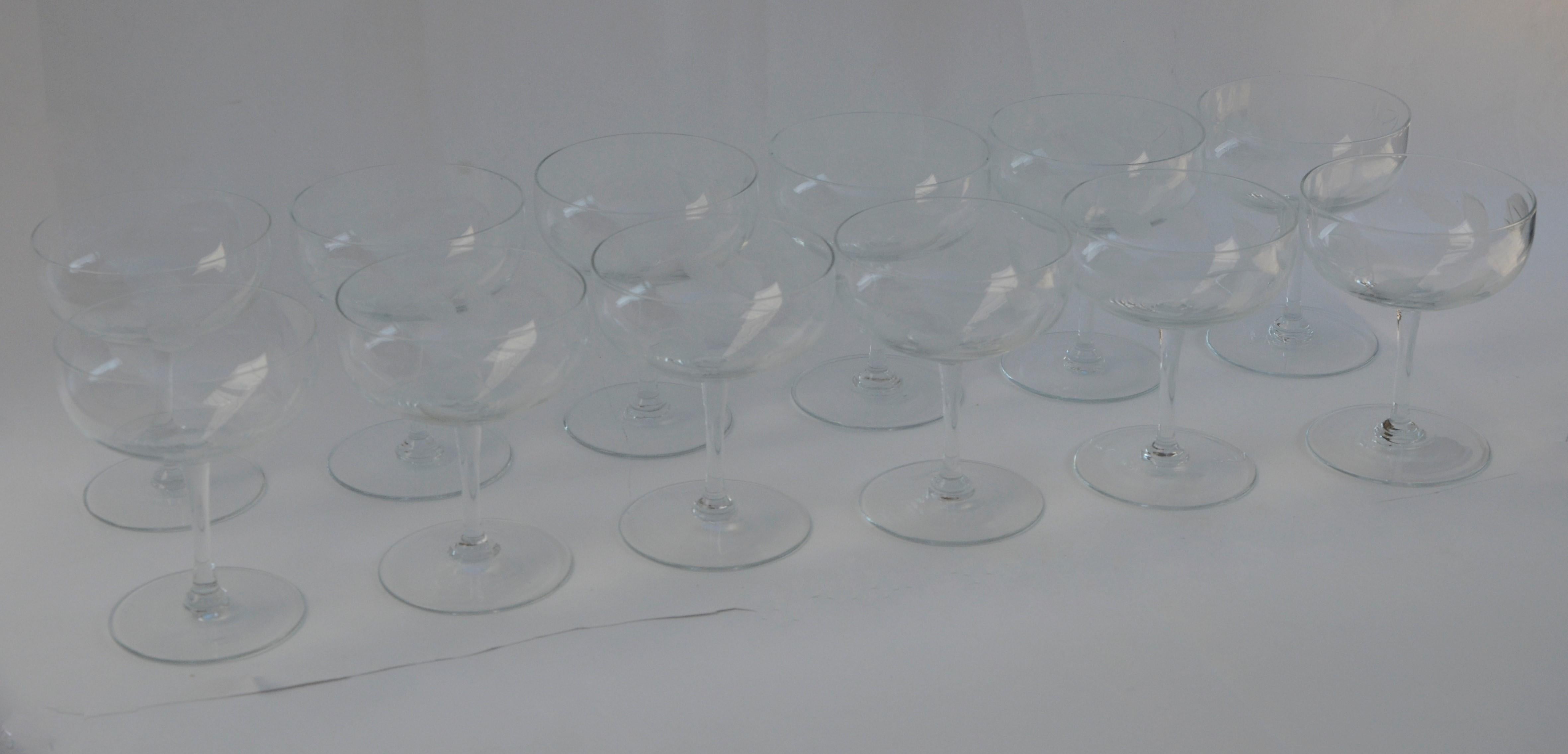 Offered is a set of twelve Mid-Century Modern cut glass frosted rose, stem and leaf theme on clear glass champagne coupes / cocktail glasses / goblets. This lovely set can be used for entertaining for events anytime during the year. Would make a