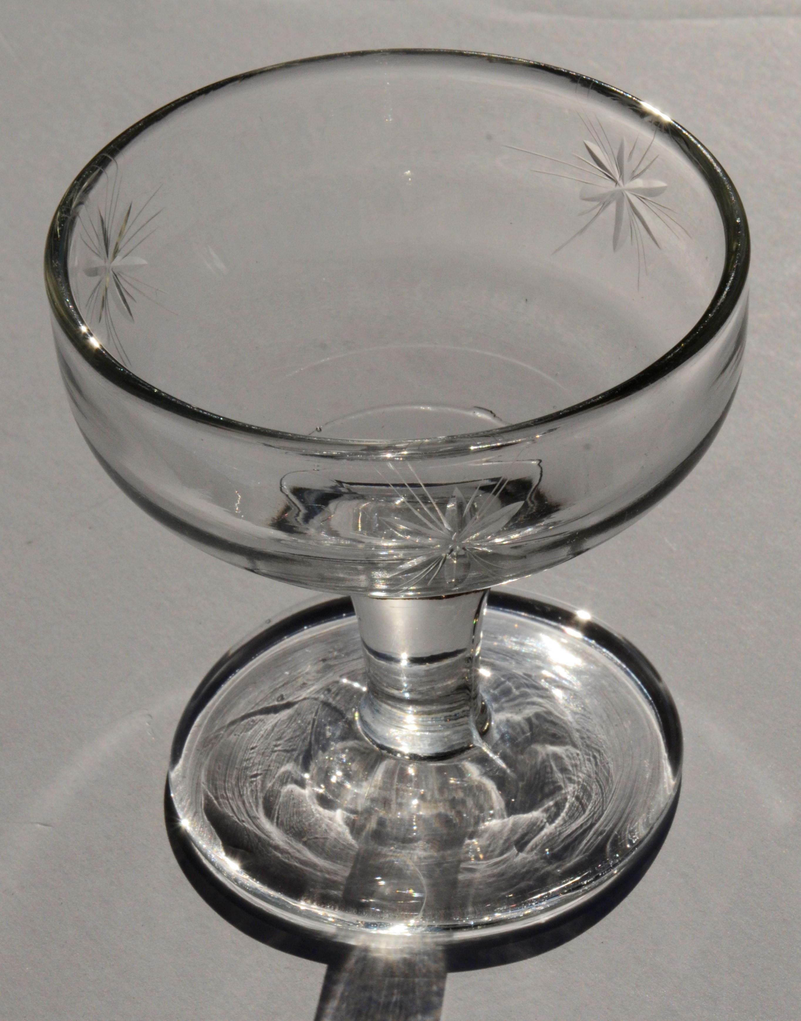 Offered is a set of six Mid-Century Modern starburst etched glass champagne coupes. Judging from the diminutive size of the glass and the style, this set of glass champagne coupes were manufactured in the mid-20th century. Perfect 