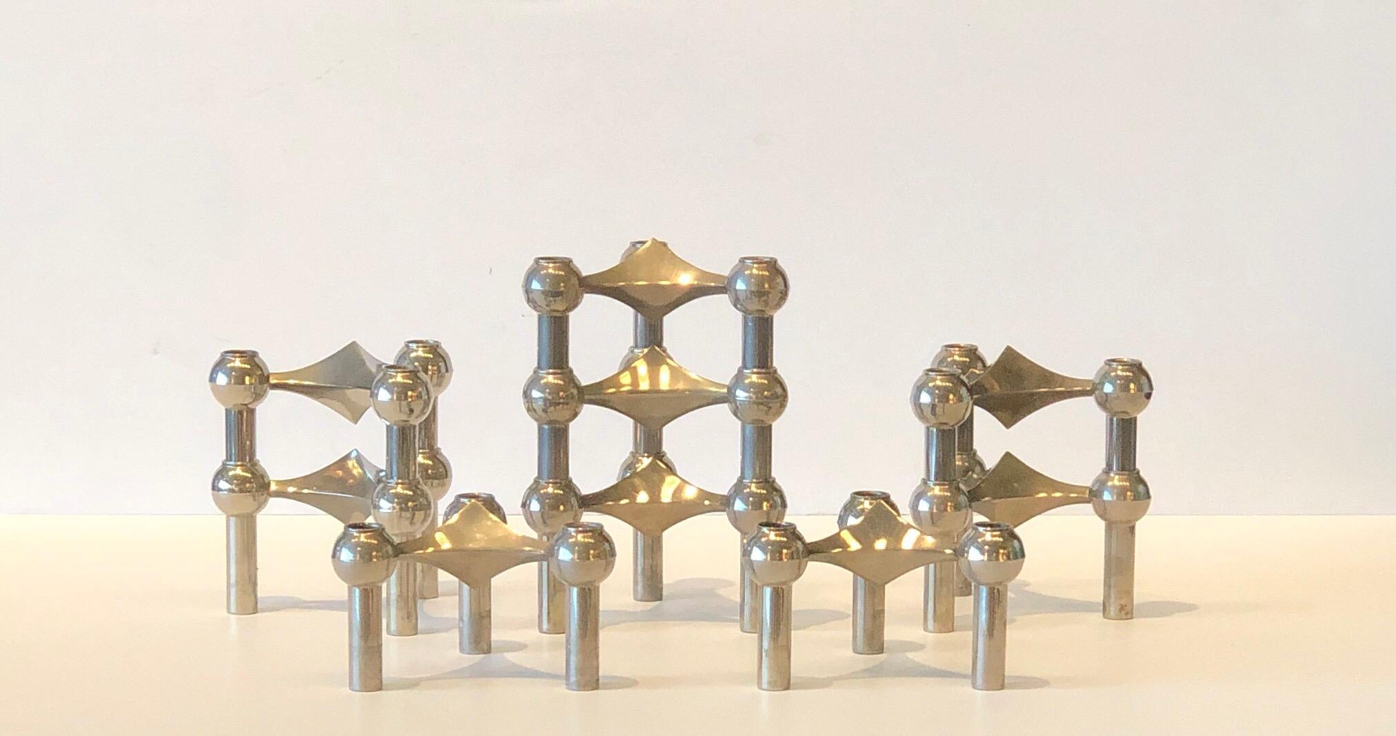 Offered is a set of nine Mid-Century Modern Caesar Stoffi for Fritz Nagel stainless steel stacking candleholders (3 candleholder in each of the 9 holders.) Quite architectural in design and versatile in configuration. Fun to put together in