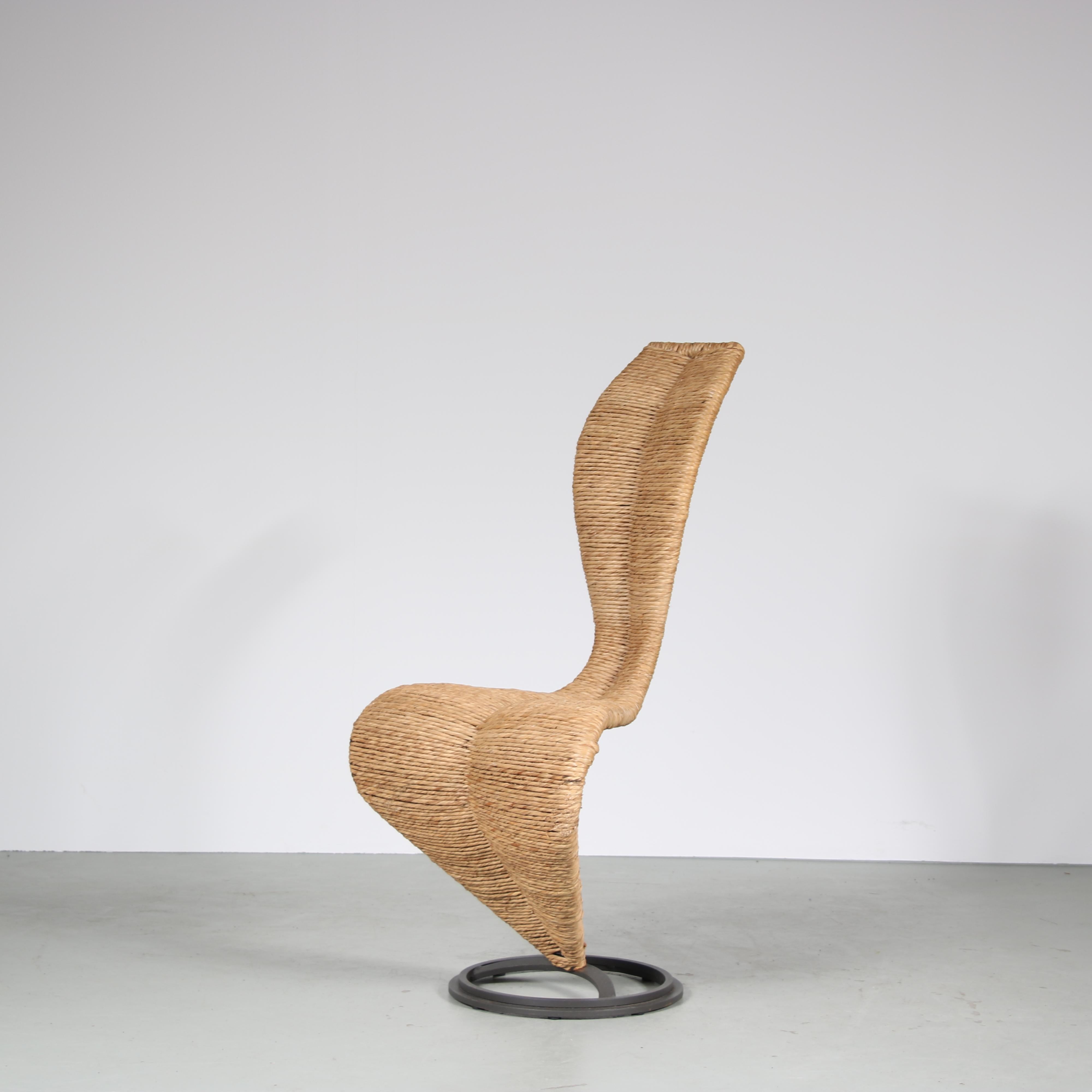 A wonderful “S Chair” designed by Tom Dixon and manufactured by Cappelini in Italy around 1980.

This elegant piece has a black metal base and is bent into a beautifully curved shape. The seat and back are fully upholstered in rope which gives