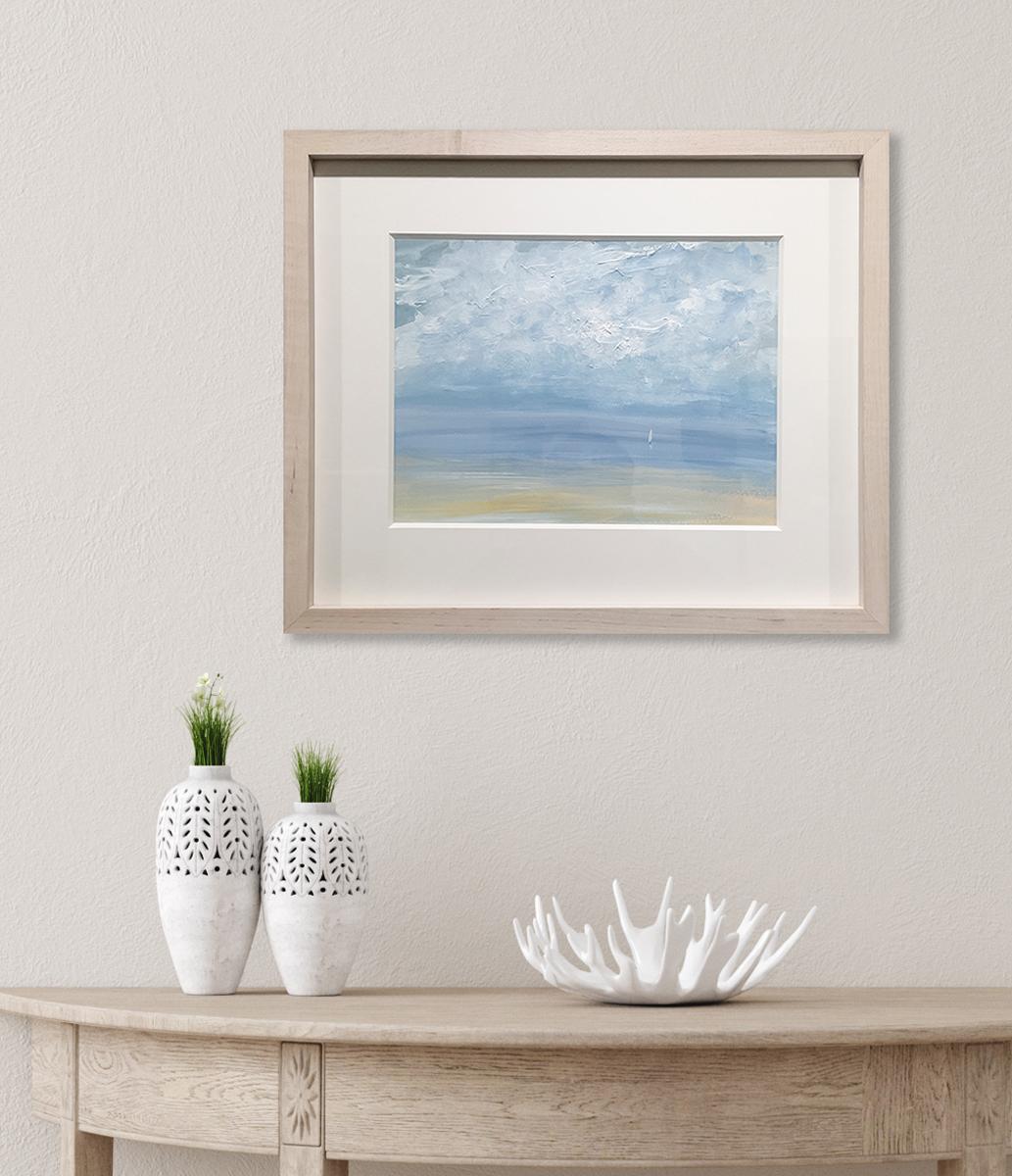 This contemporary seascape painting by S.C. Aldo is made with acrylic paint on Arches paper. It depicts a loose, abstracted coastal scene with a light blue sky, textured abstract clouds and a small white sailboat sailing near the horizon. A sandy