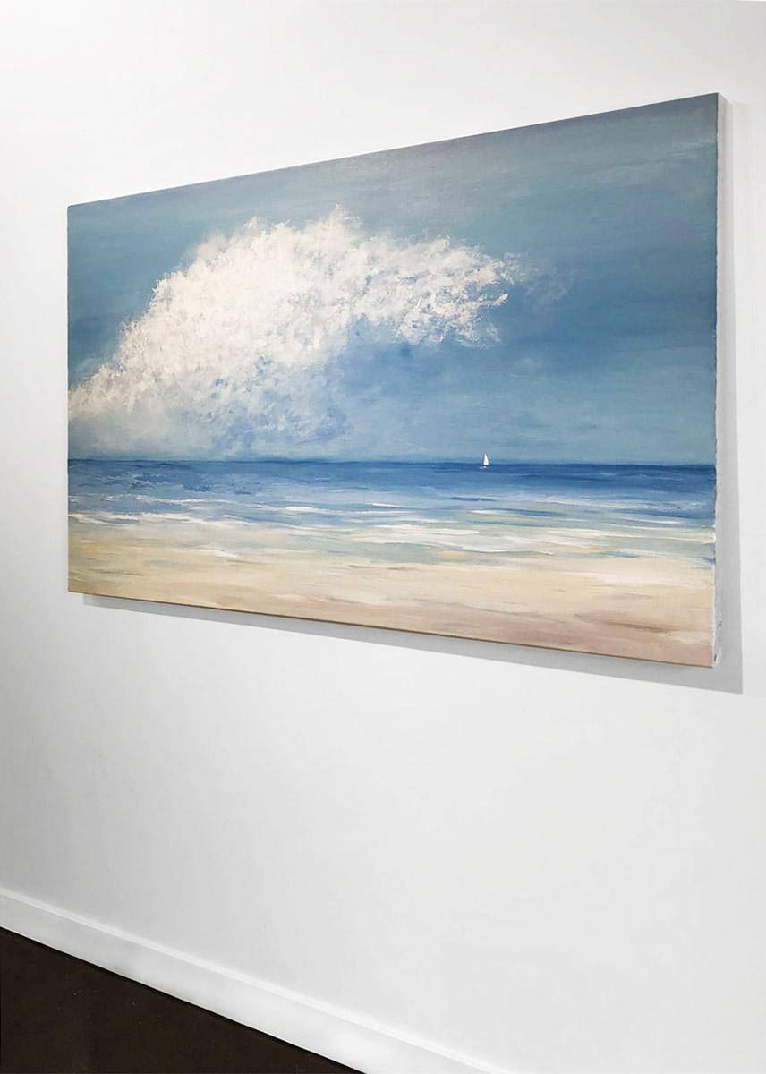 This coastal painting by S. Cora Aldo depicts an impressionistic ocean view. Sand-colored tones extend from the bottom of the composition and fade to a muted blue, with painterly streaks of white along the beginning of the shoreline. The sky is a