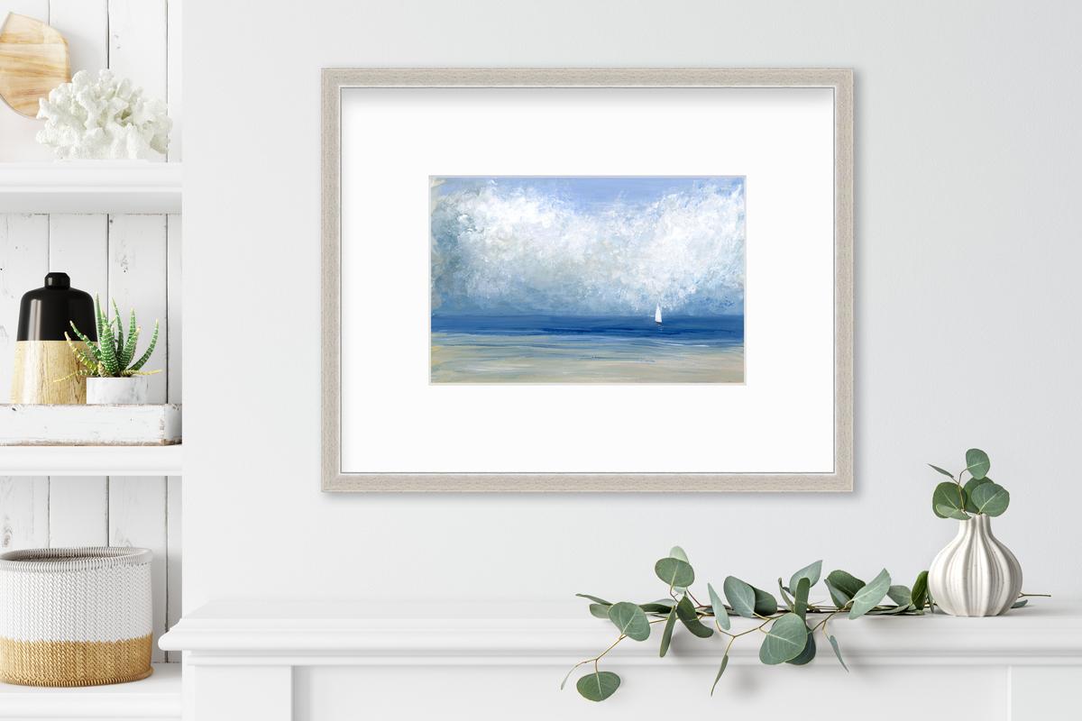 This limited edition contemporary seascape print by S.C. Aldo features a cool coastal palette. It depicts a lightly abstracted coastal scene with a light blue sky, thick, white abstracted clouds, and a small sailboat floating off a sandy shoreline