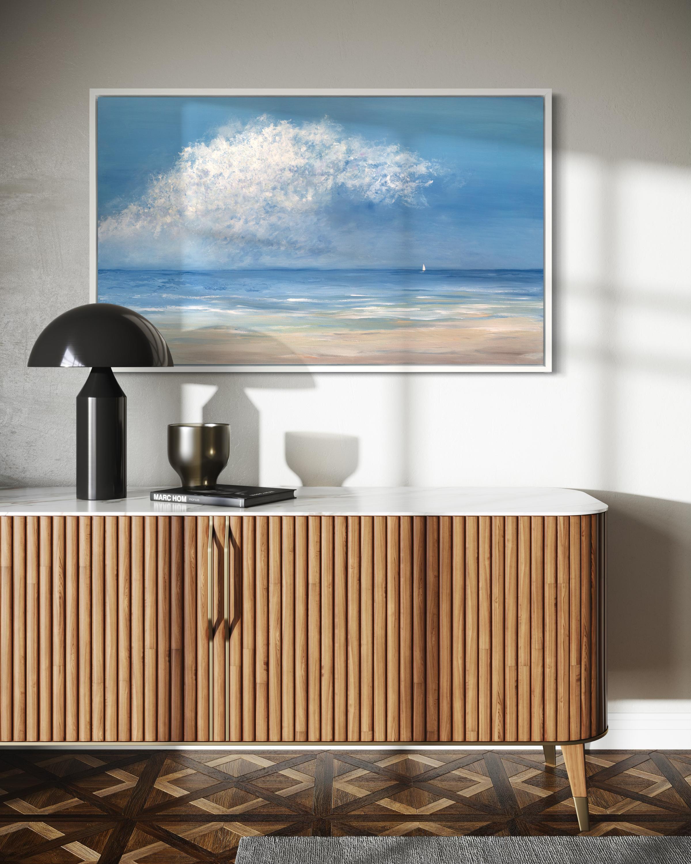 This limited edition print by S. Cora Aldo depicts an impressionistic ocean view. Sand-colored tones extend from the bottom of the composition and fade to a muted blue, with strokes of white along the beginning of the shoreline. The sky is a blend
