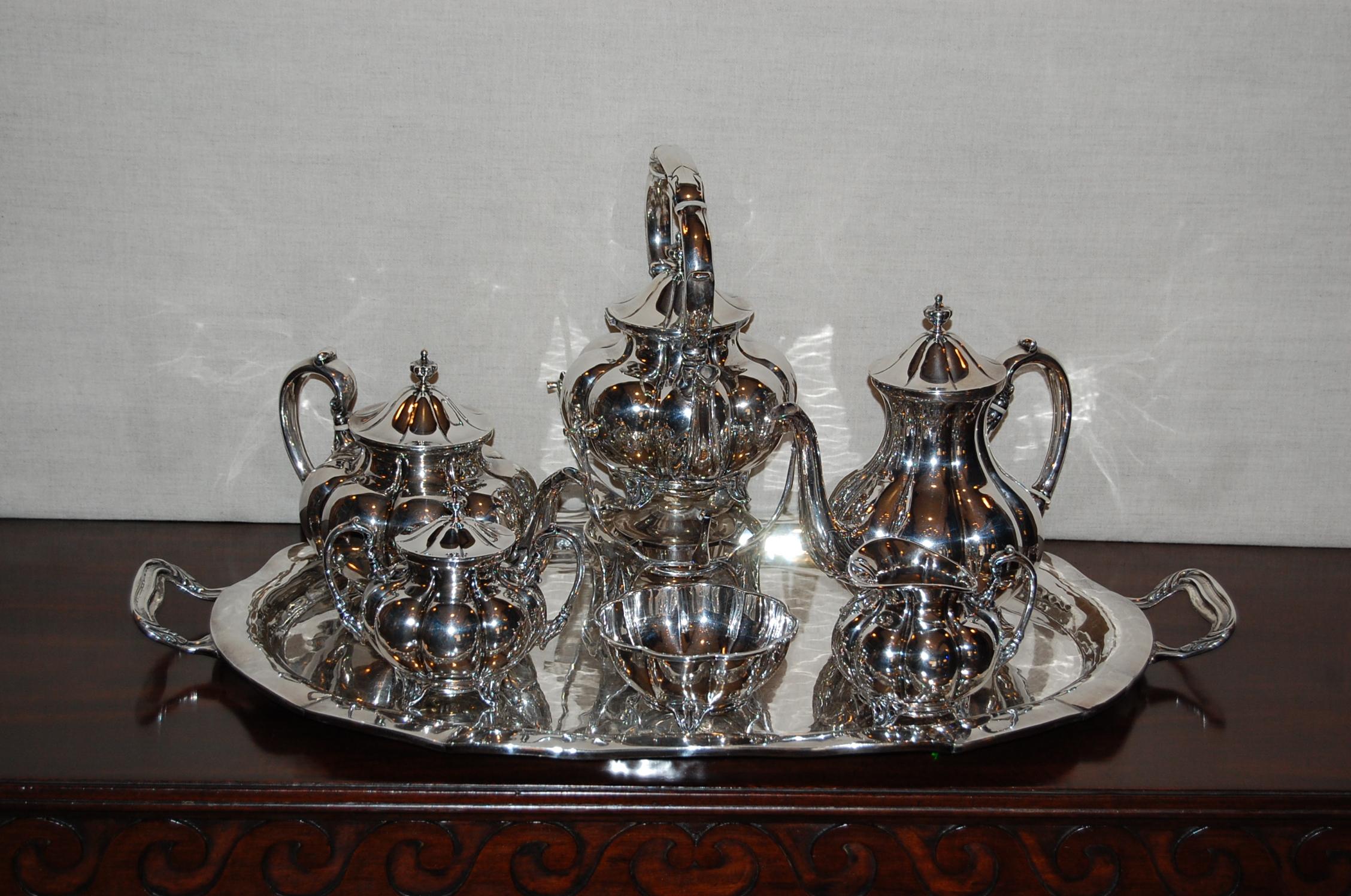 S. de la Serna sterling silver tea set with tray in very good to excellent condition, there are scratches in the tray, which would likely buff out professionally. This set and tray are not monogrammed.

Large sterling silver 6-piece tea set with