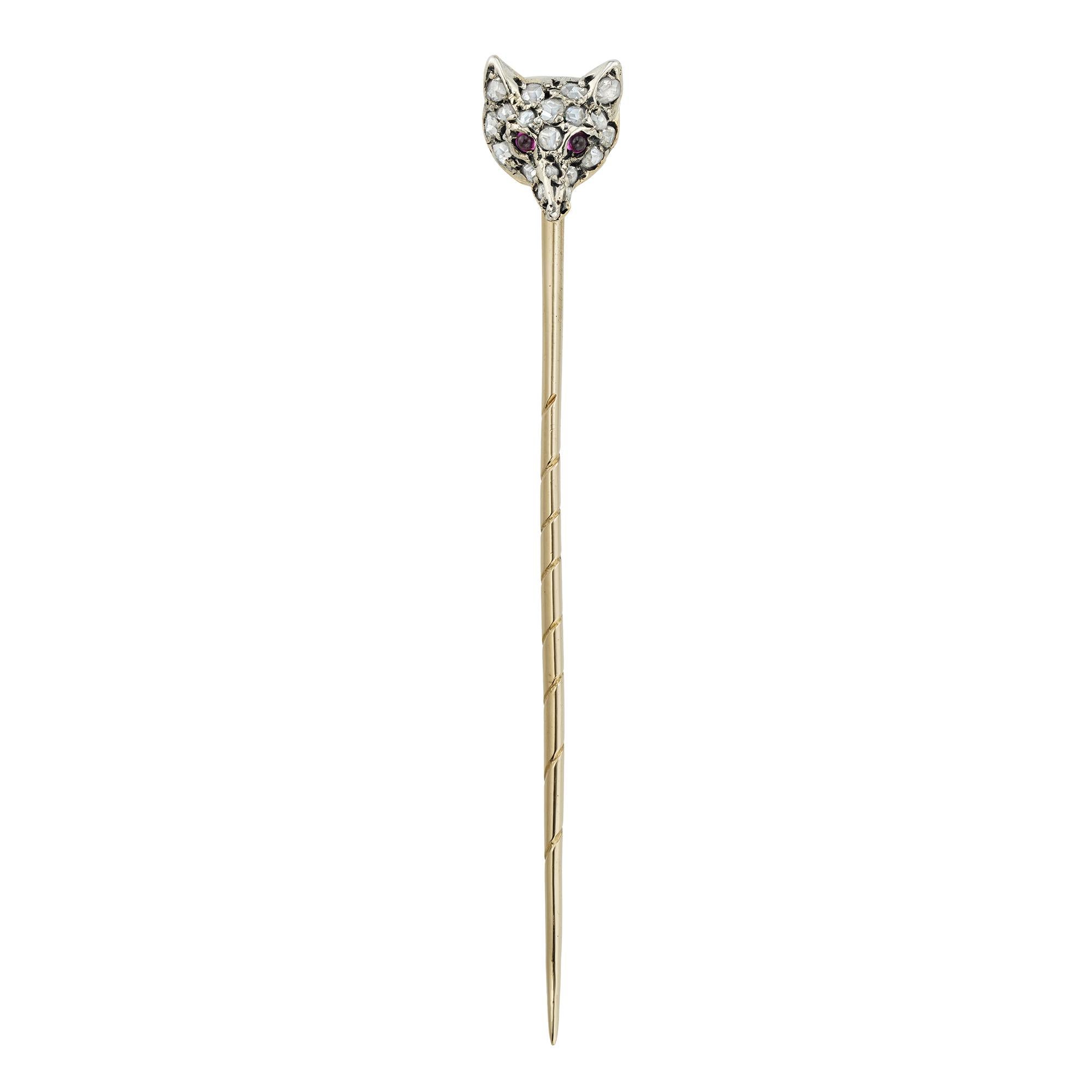 A late Victorian fox-head stickpin, set with nineteen rose-cut diamonds and two cabochon-cut ruby-set eye, mounted in silver to yellow gold, with gold pin fitting, circa 1890, measuring 0.8 x 0.7cm, the pin measuring 5cm long, gross weight 1.6