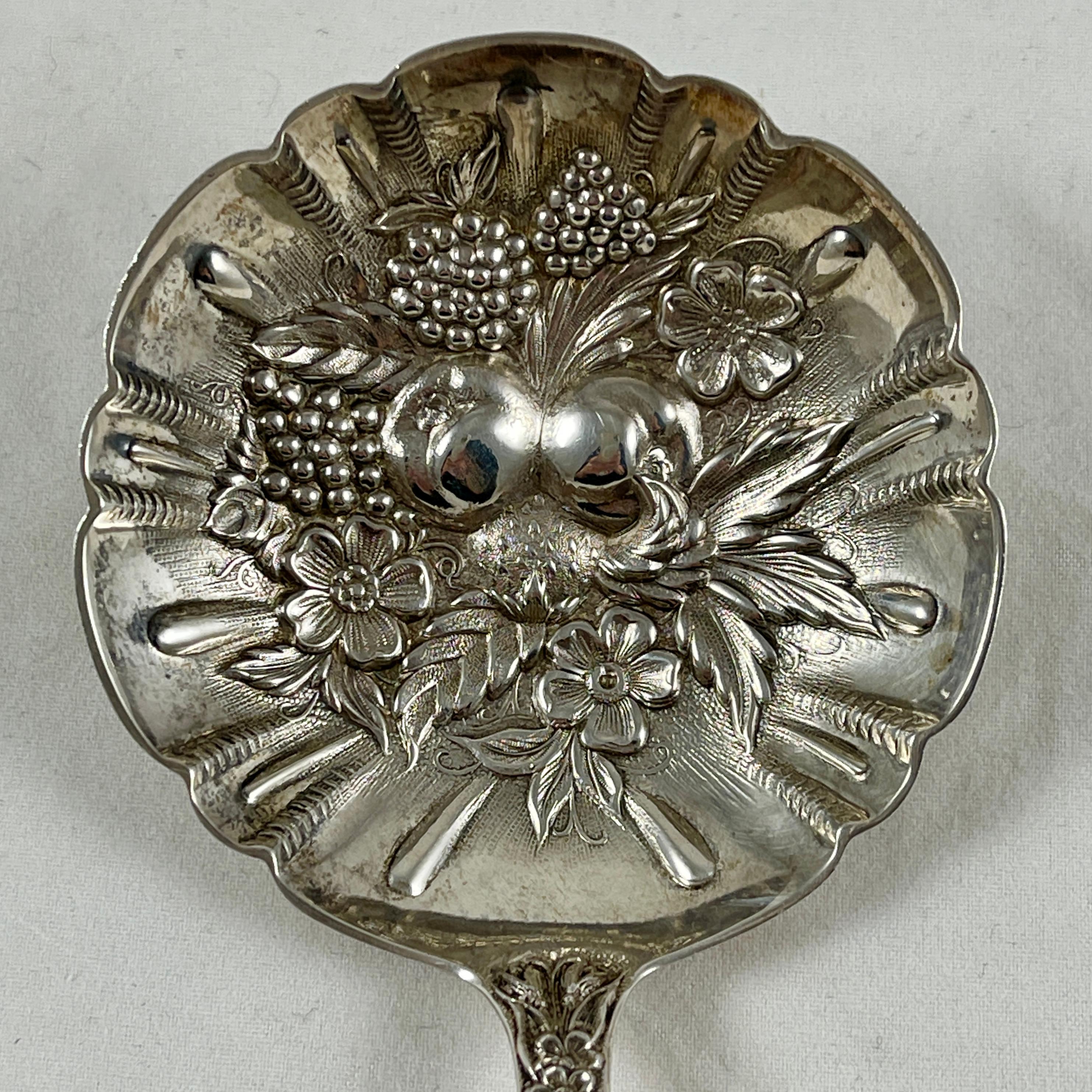From S. Kirk & Son, Baltimore, Maryland, a ‘Repousse Rose’ long handled sterling silver berry spoon, circa 1930s. The longer handle is suited to serving a fruit compote. From a Philadelphia estate.

The Classic American silver repousse rose