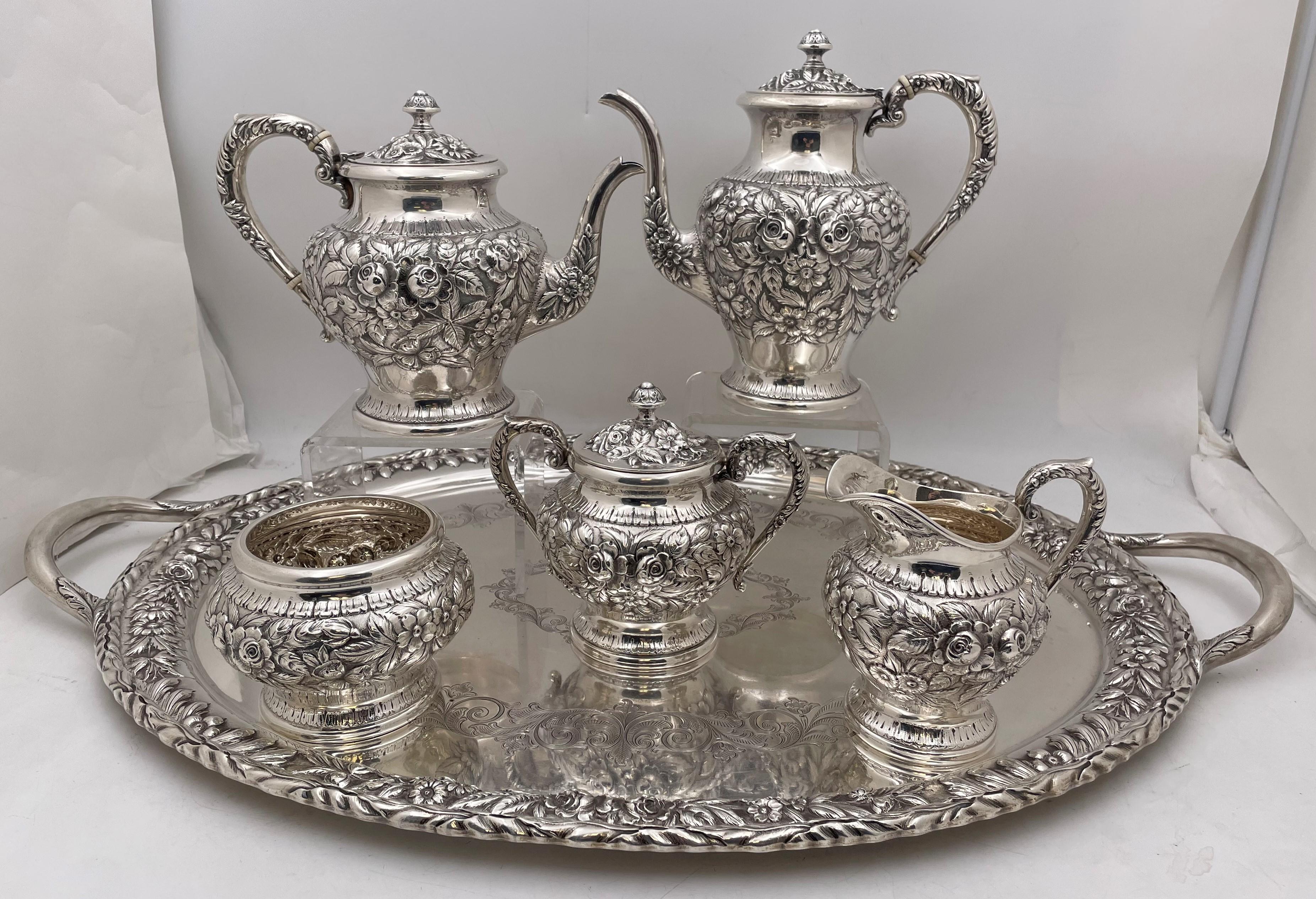 S. Kirk & Son, sterling silver repousse, hand chased and hand decorated tea and coffee set, all matching, richly adorned with crisp floral motifs, in pattern number 474F from 1932, consisting of:

- a tray measuring 28 1/2'' from handle to handle