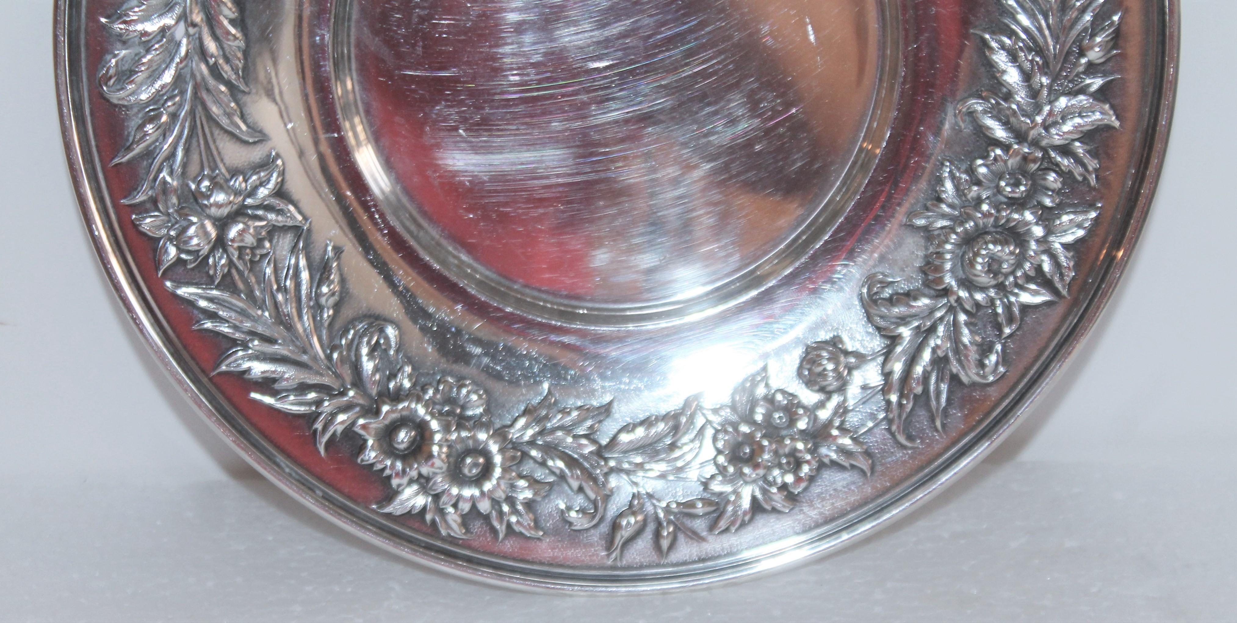 This fine handcrafted sterling silver and heavy weight floral repose round serving platter is signed on the base and marked 