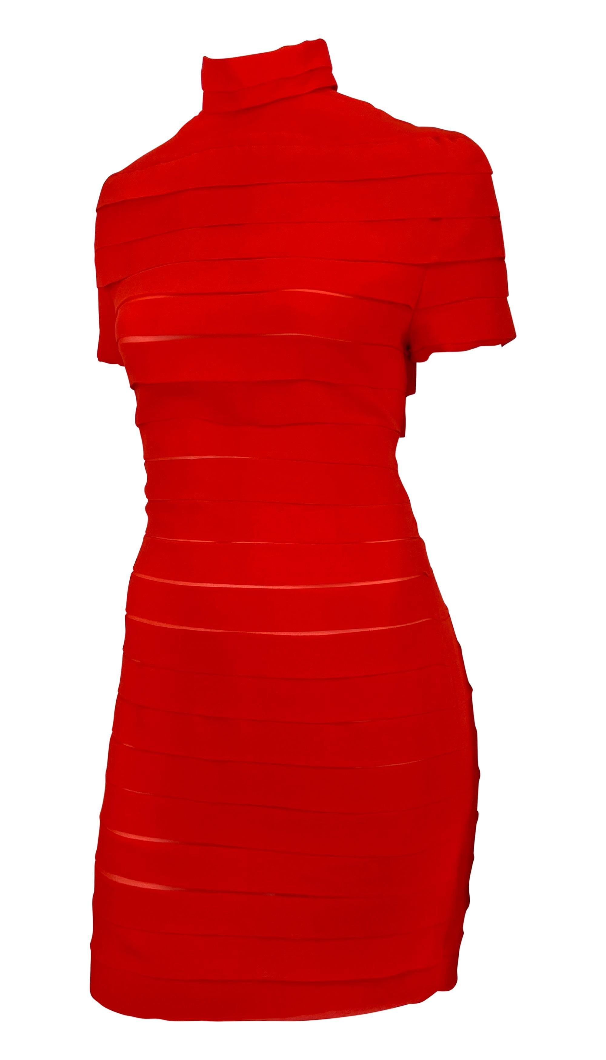 This Gianni Versace dress from the Spring/Summer 1987 collection features a striking bandage-style design in bold red. The form-fitting silhouette is accented with horizontal layered bands, a mock neck, and short sleeves, reflecting the structured