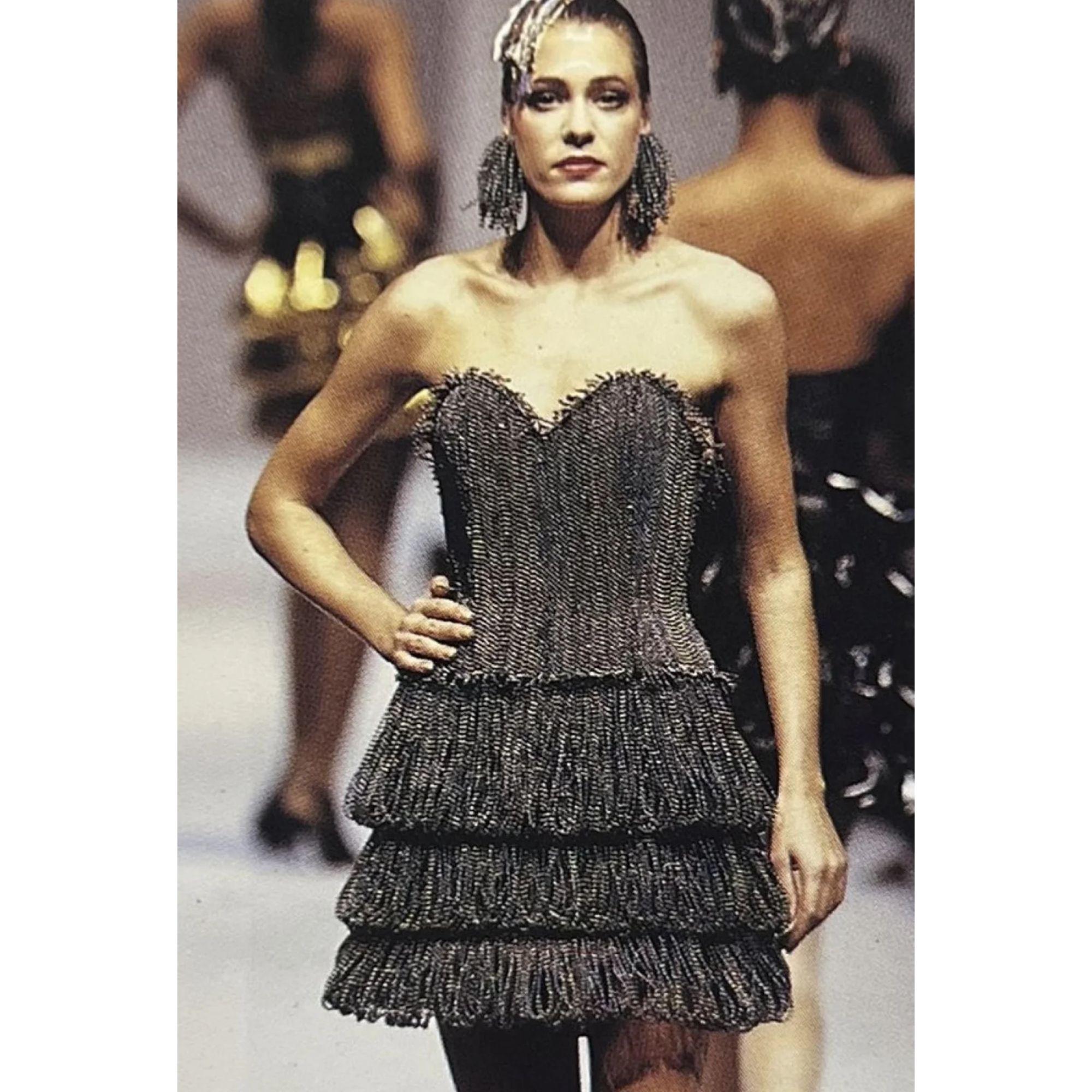S/S 1988 Paco Rabanne Haute Couture iridescent beaded bustier, skirt, and earring set. Structured strapless bustier featuring beaded 'fringe' at bust and hem ties in back with silk satin bow. Pairs perfectly with three-tiered beaded mini skirt with